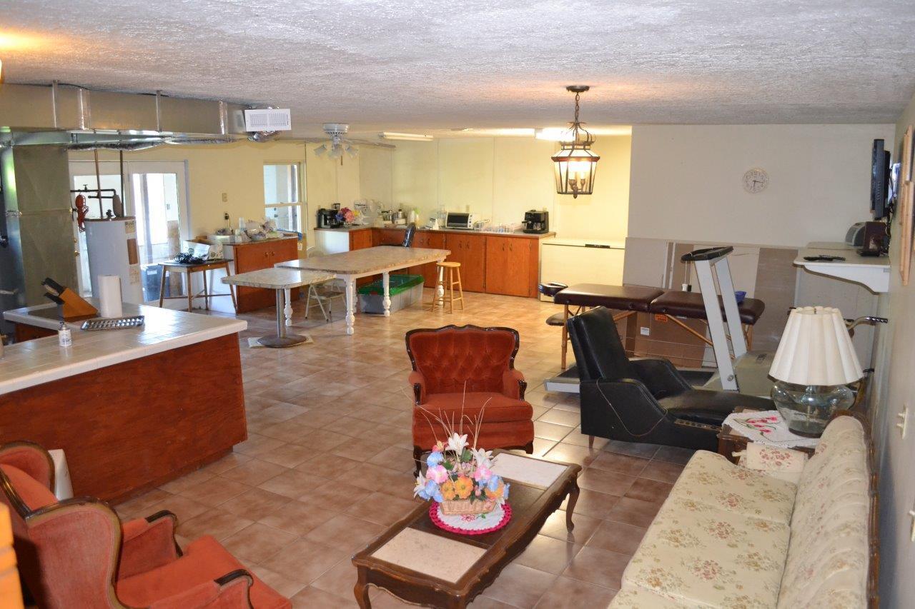 289 Radford Road Southeast Floyd, VA 24091 - Photo 24 of 32 a living room with lots of furniture and a chandelier