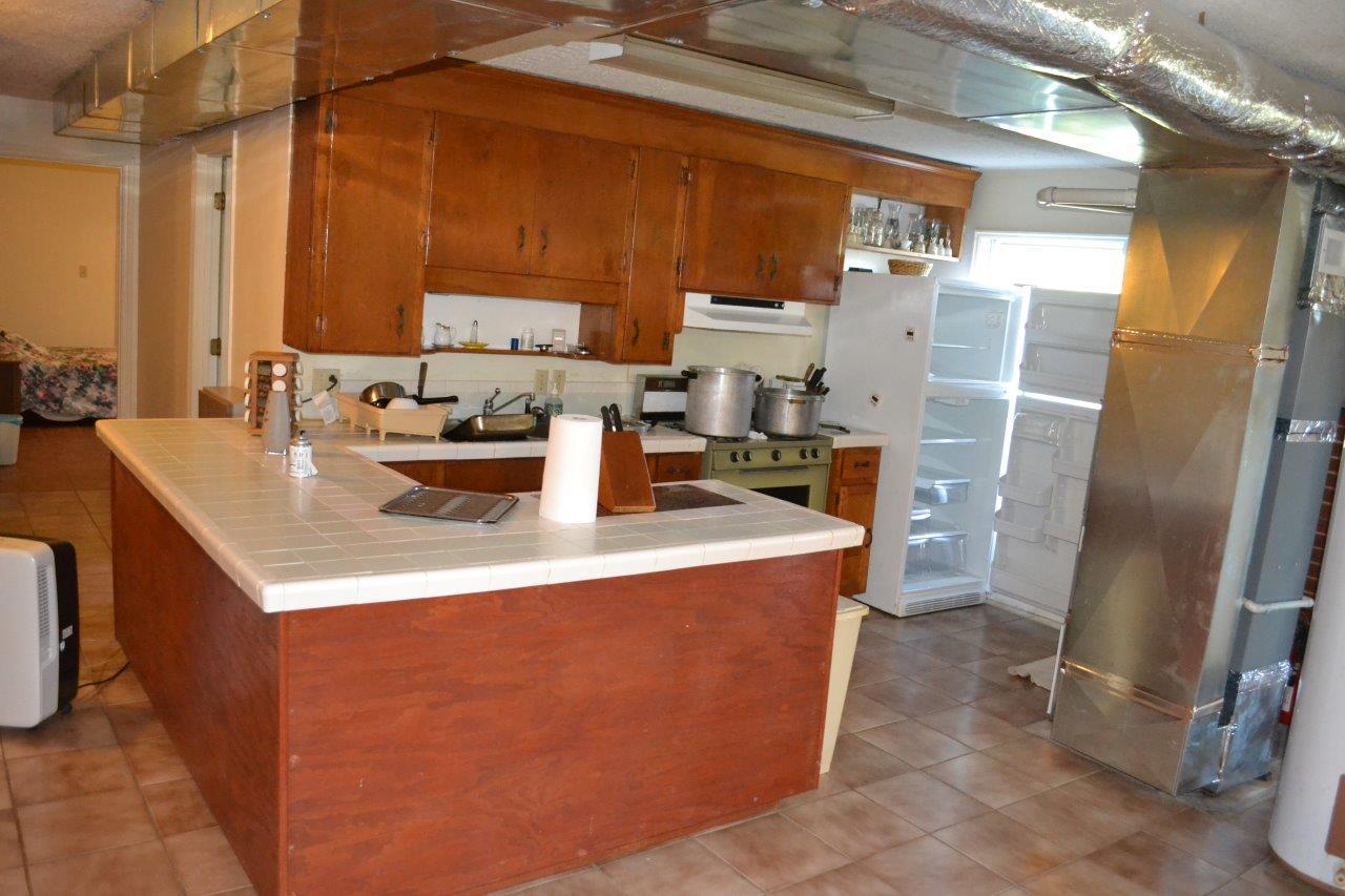 289 Radford Road Southeast Floyd, VA 24091 - Photo 25 of 32 a kitchen with a sink a stove and a refrigerator