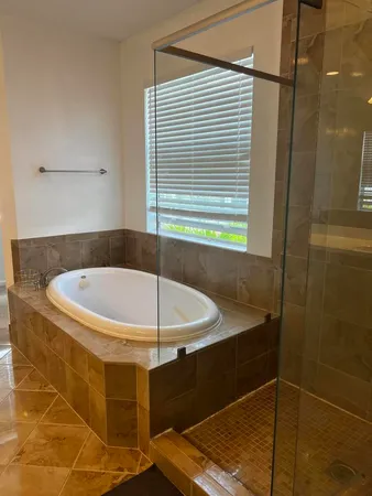 a bathroom with a tub and shower