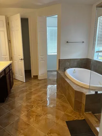 a bathroom with a tub and shower