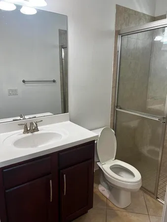 a bathroom with a toilet a sink and a mirror