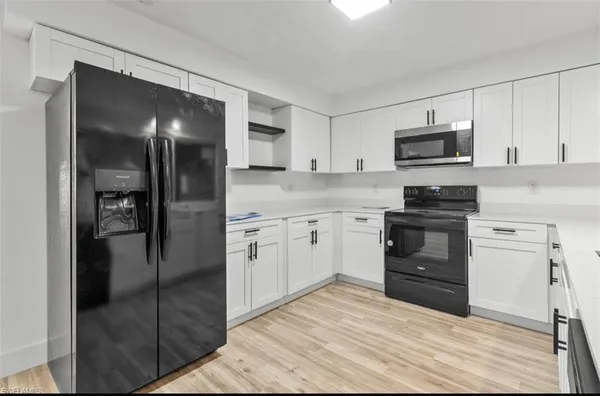 a kitchen with a refrigerator stove and microwave