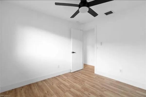a view of a room with wooden floor and windows