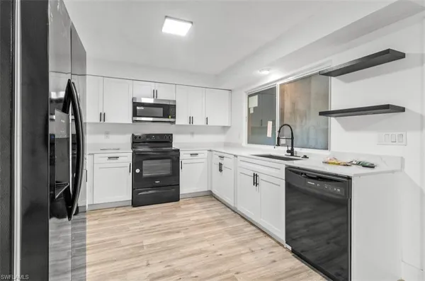 a kitchen with a sink stove and refrigerator
