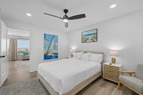 a bedroom with a large bed and a chandelier