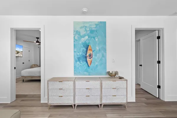 a bedroom with a large bed and a chandelier