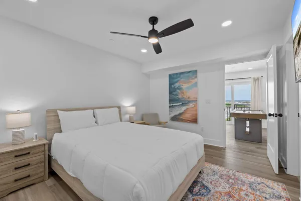 a bedroom with a bed and a painting on the wall