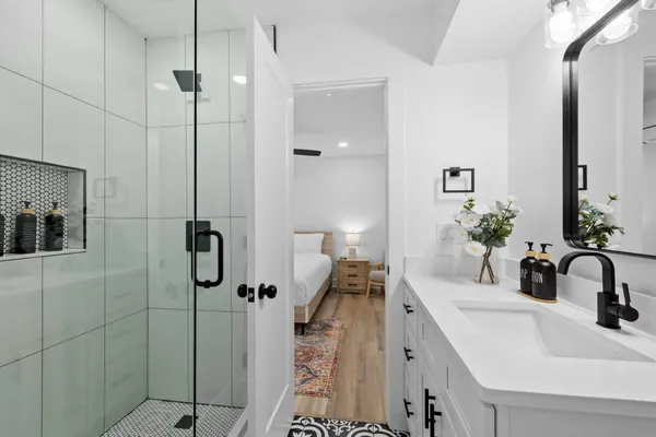 a bathroom with a sink toilet and shower