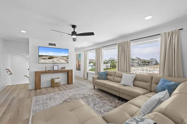 a living room with furniture and wooden floor