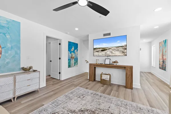 a bedroom with a bed and a painting on the wall