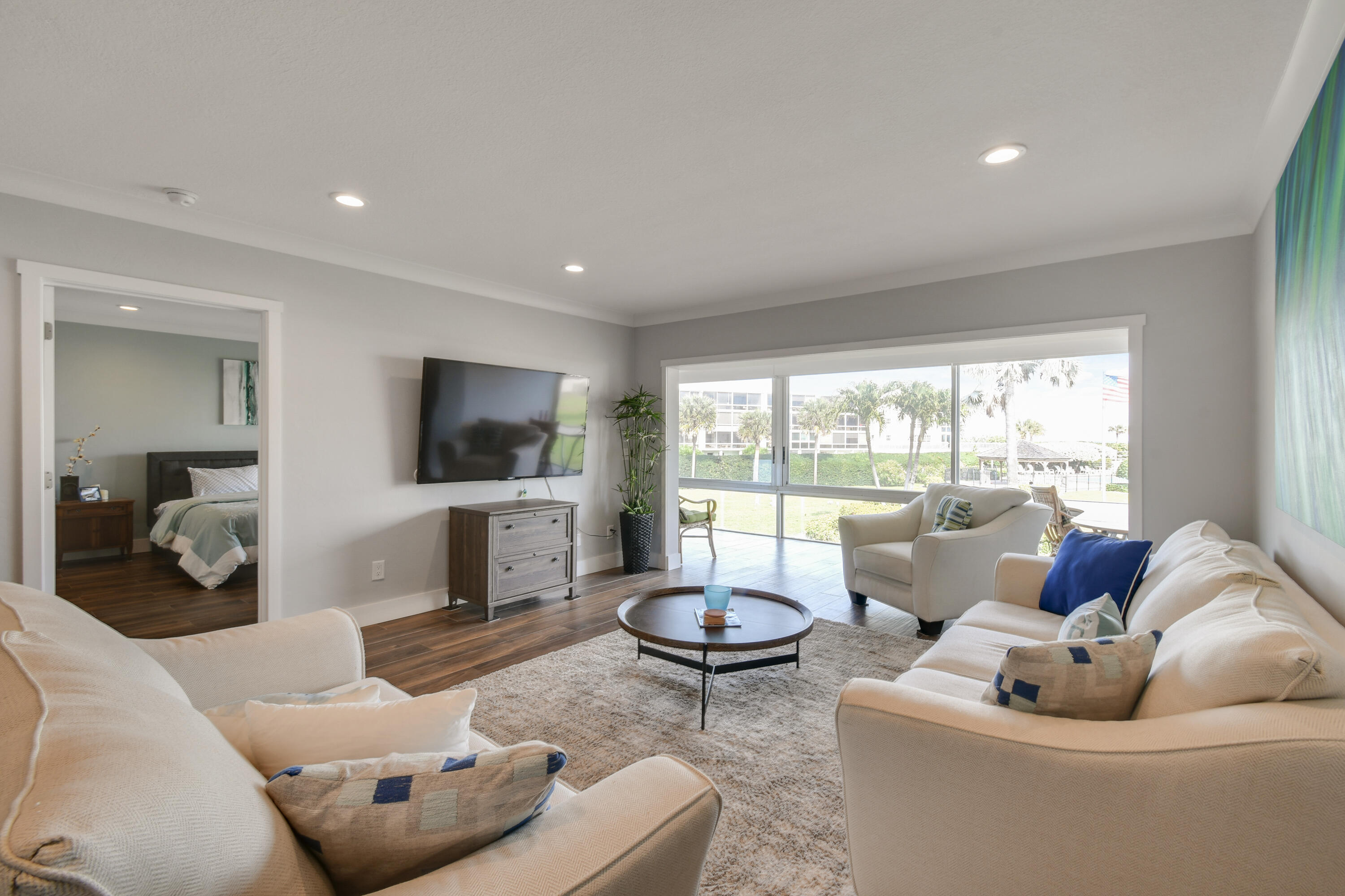 80 Celestial Way, Unit 211 Juno Beach, FL 33408 - Photo 13 of 45 a living room with furniture and a flat screen tv