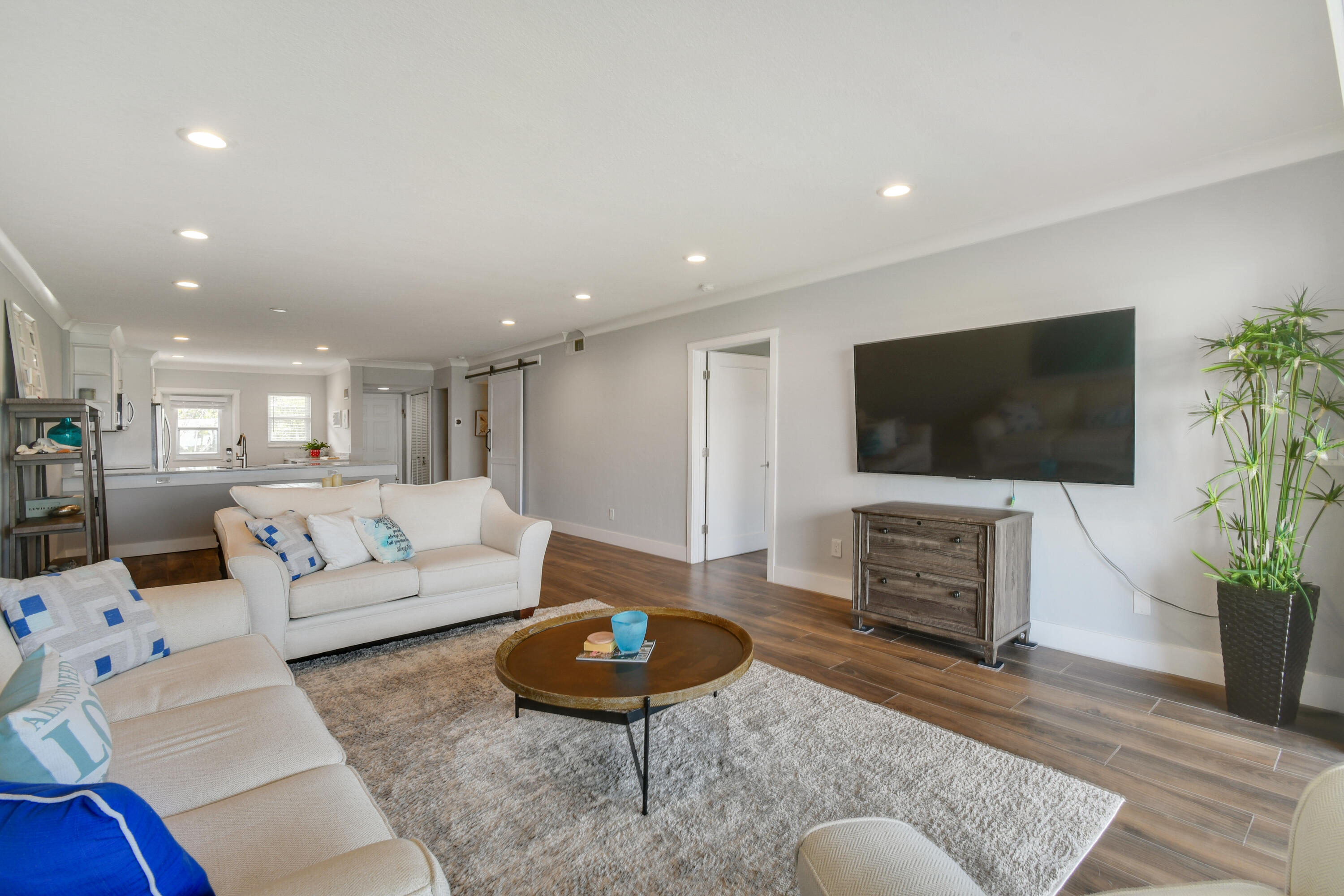 80 Celestial Way, Unit 211 Juno Beach, FL 33408 - Photo 15 of 45 a living room with furniture and a flat screen tv