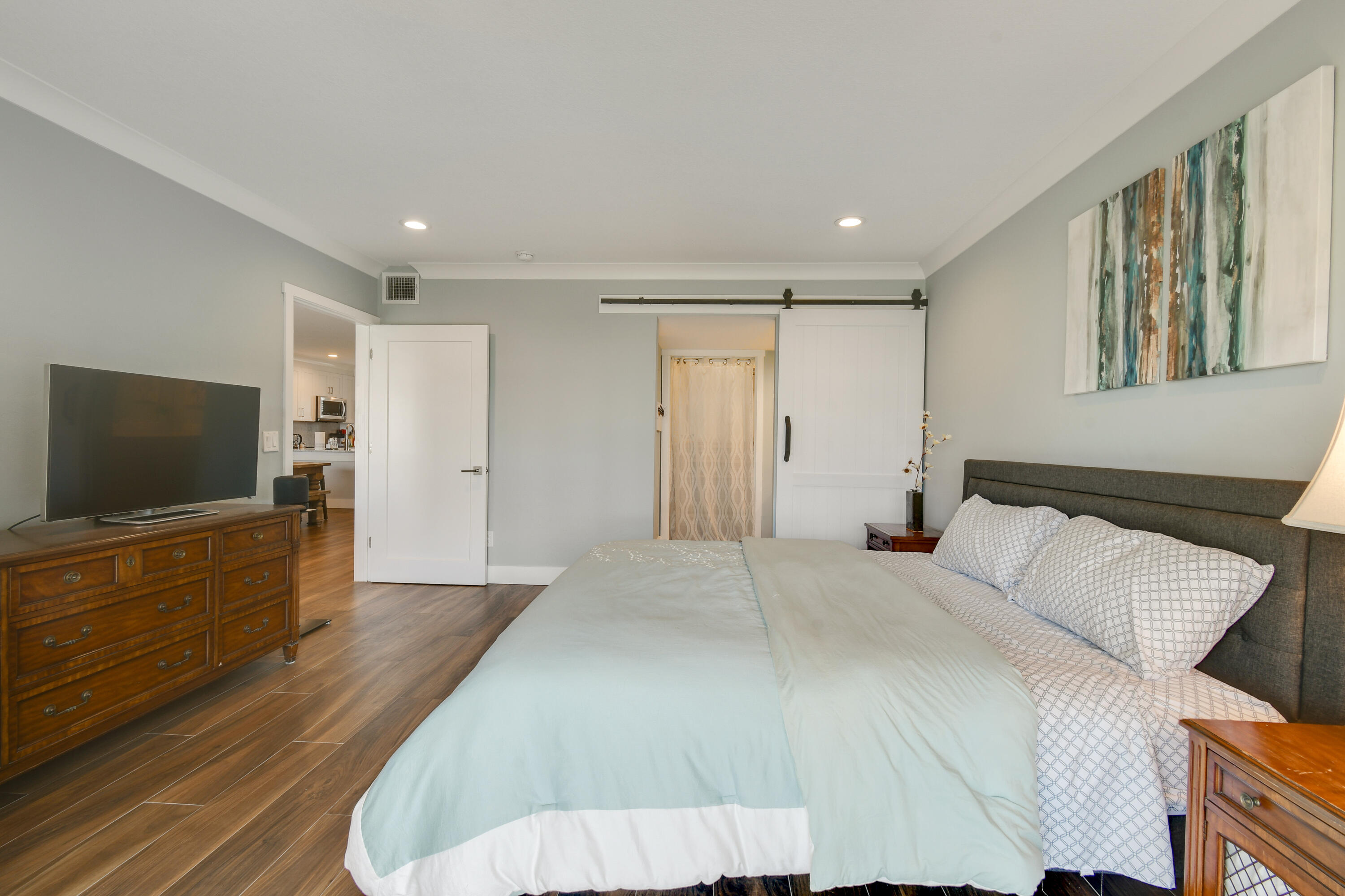 80 Celestial Way, Unit 211 Juno Beach, FL 33408 - Photo 19 of 45 a bedroom with a bed and a flat screen tv