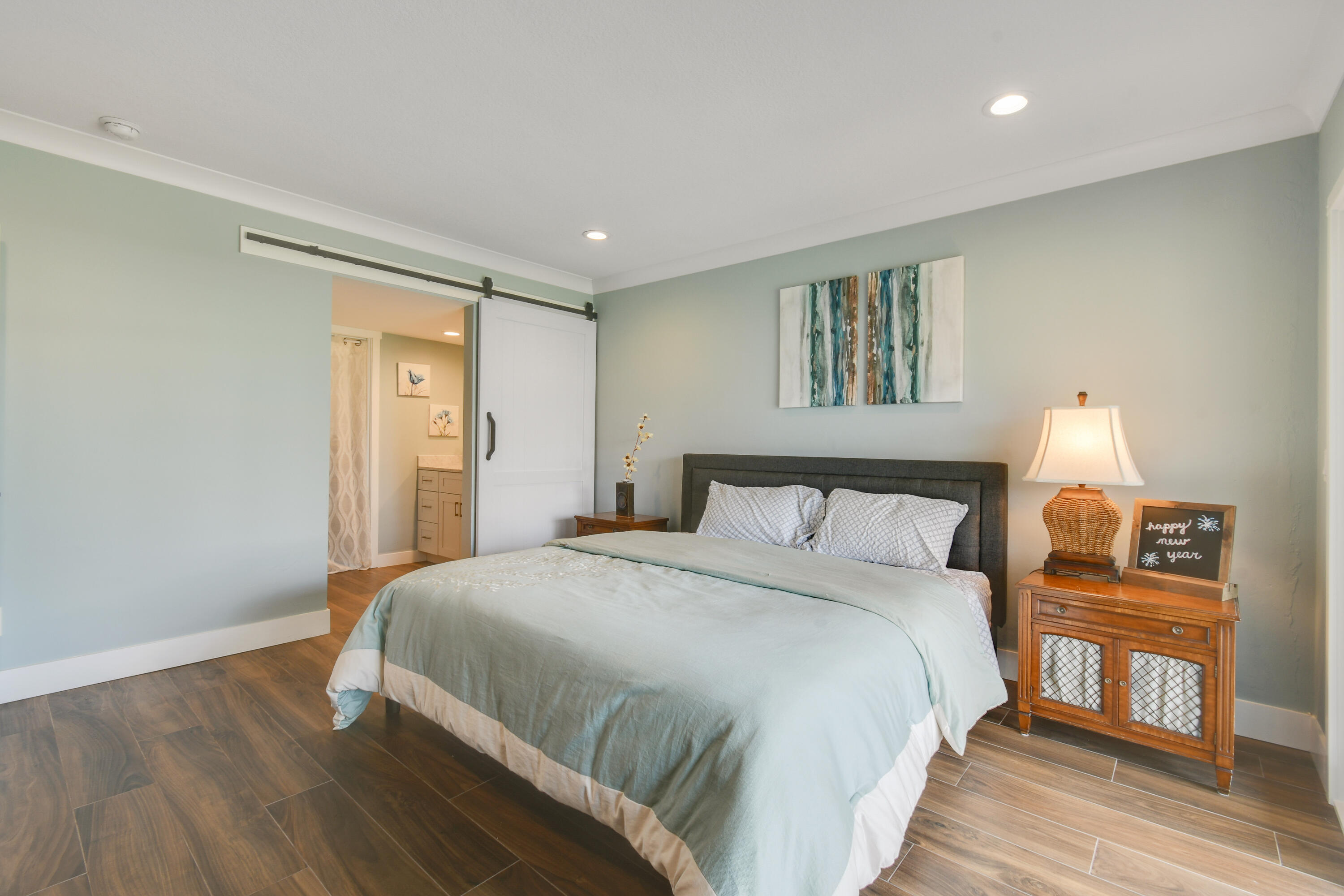 80 Celestial Way, Unit 211 Juno Beach, FL 33408 - Photo 20 of 45 a bedroom with a bed and a night stand