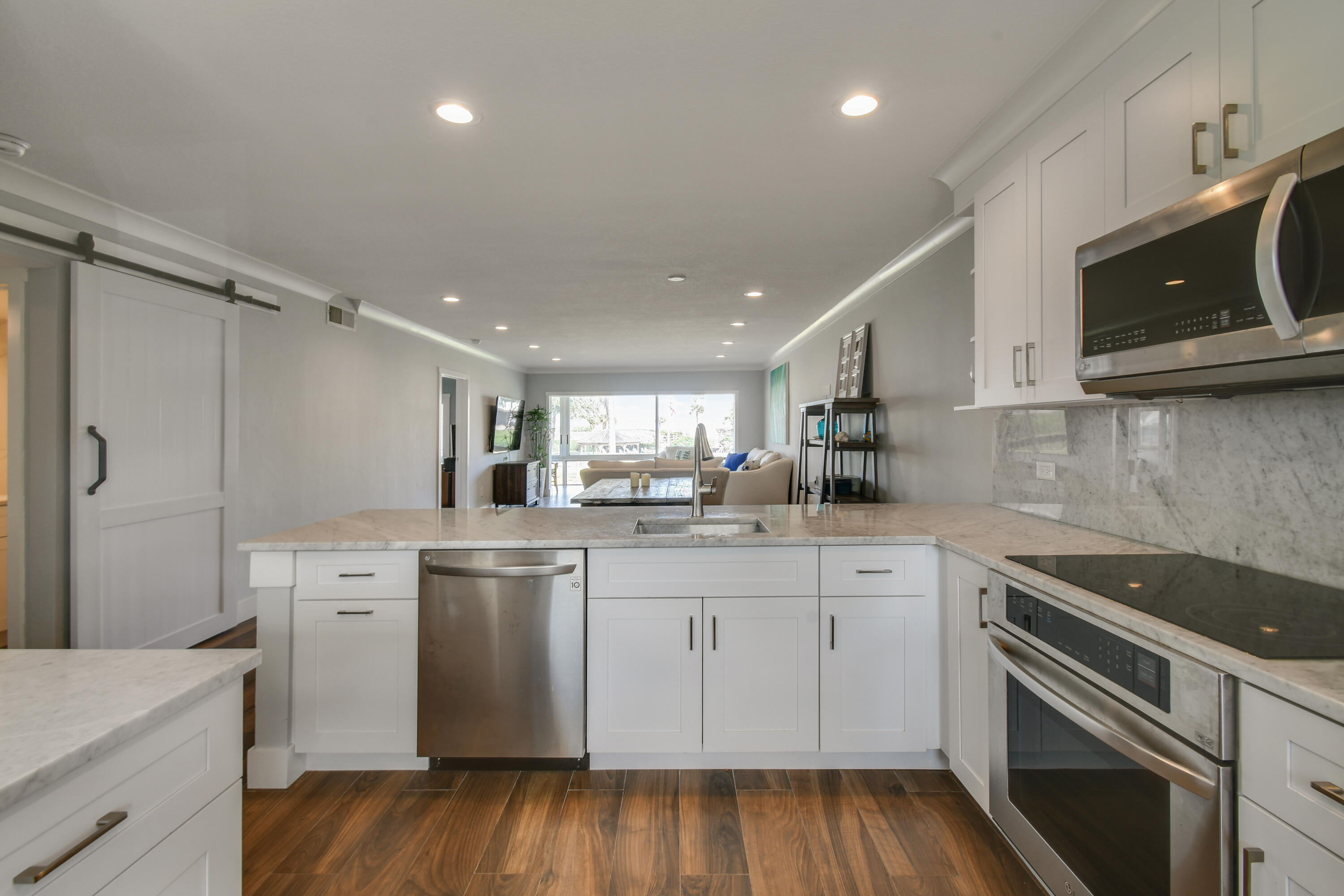 80 Celestial Way, Unit 211 Juno Beach, FL 33408 - Photo 2 of 45 a kitchen with a sink a microwave and cabinets
