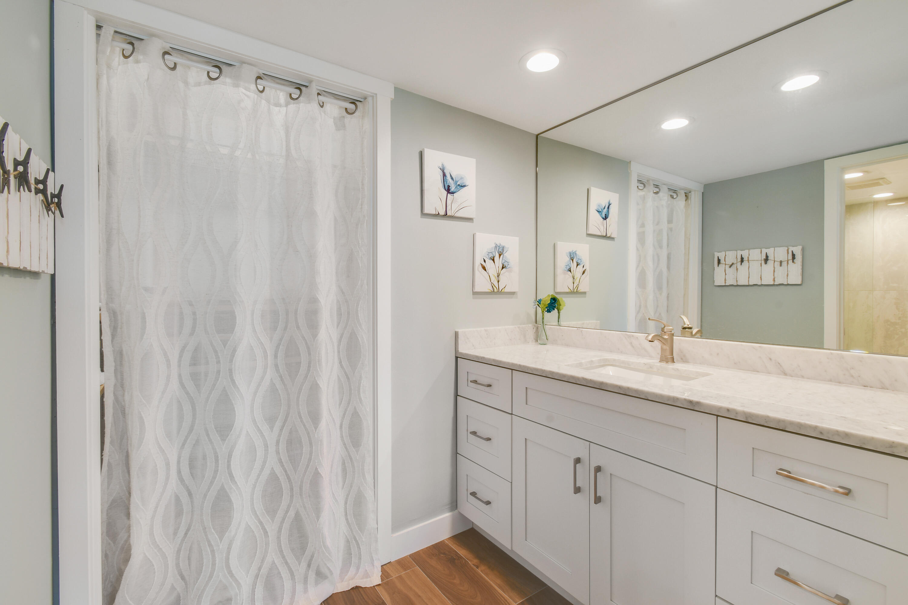 80 Celestial Way, Unit 211 Juno Beach, FL 33408 - Photo 24 of 45 a bathroom with a double vanity sink and mirror