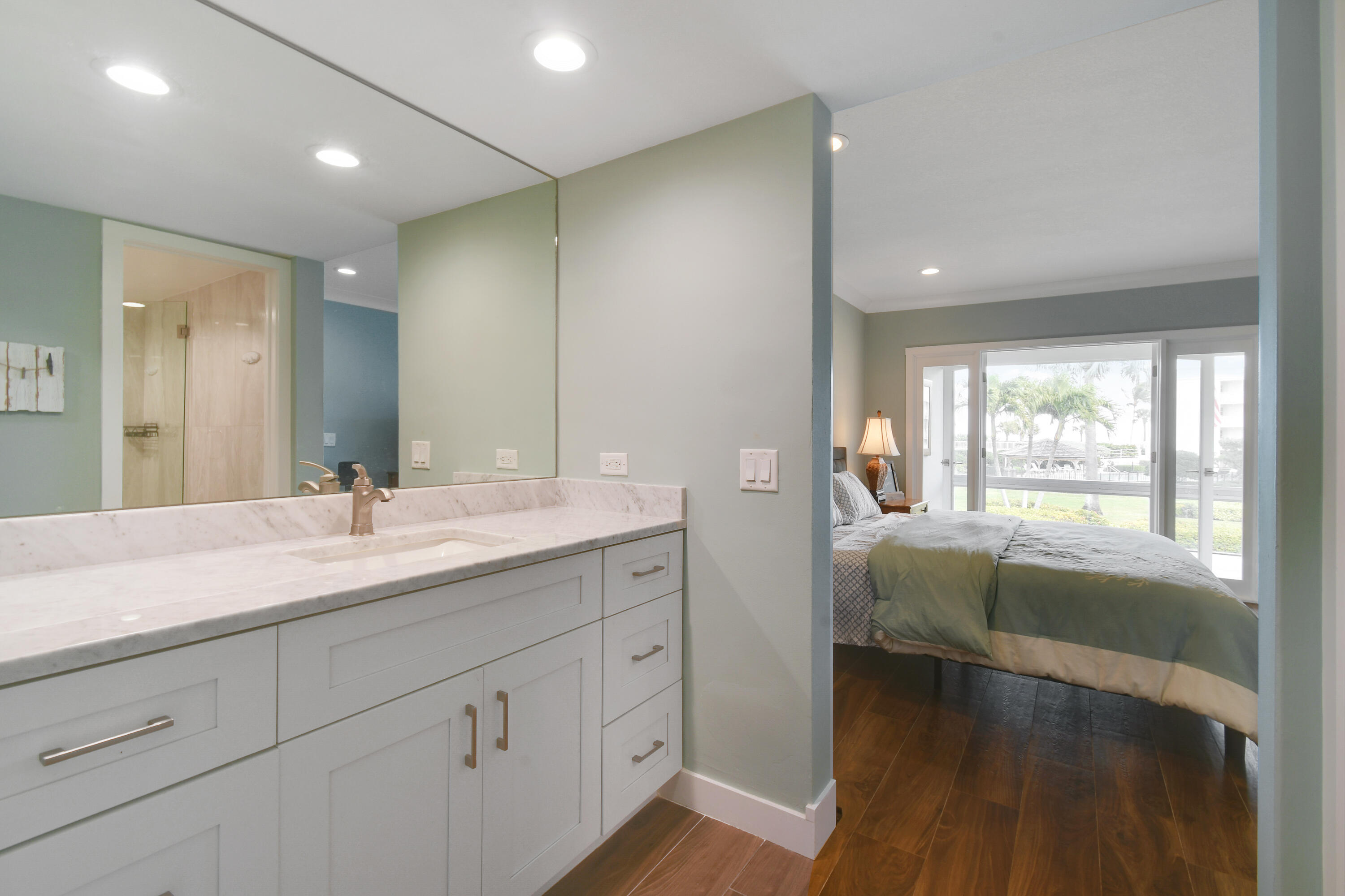 80 Celestial Way, Unit 211 Juno Beach, FL 33408 - Photo 25 of 45 a spacious bathroom with a double vanity sink and a large mirror