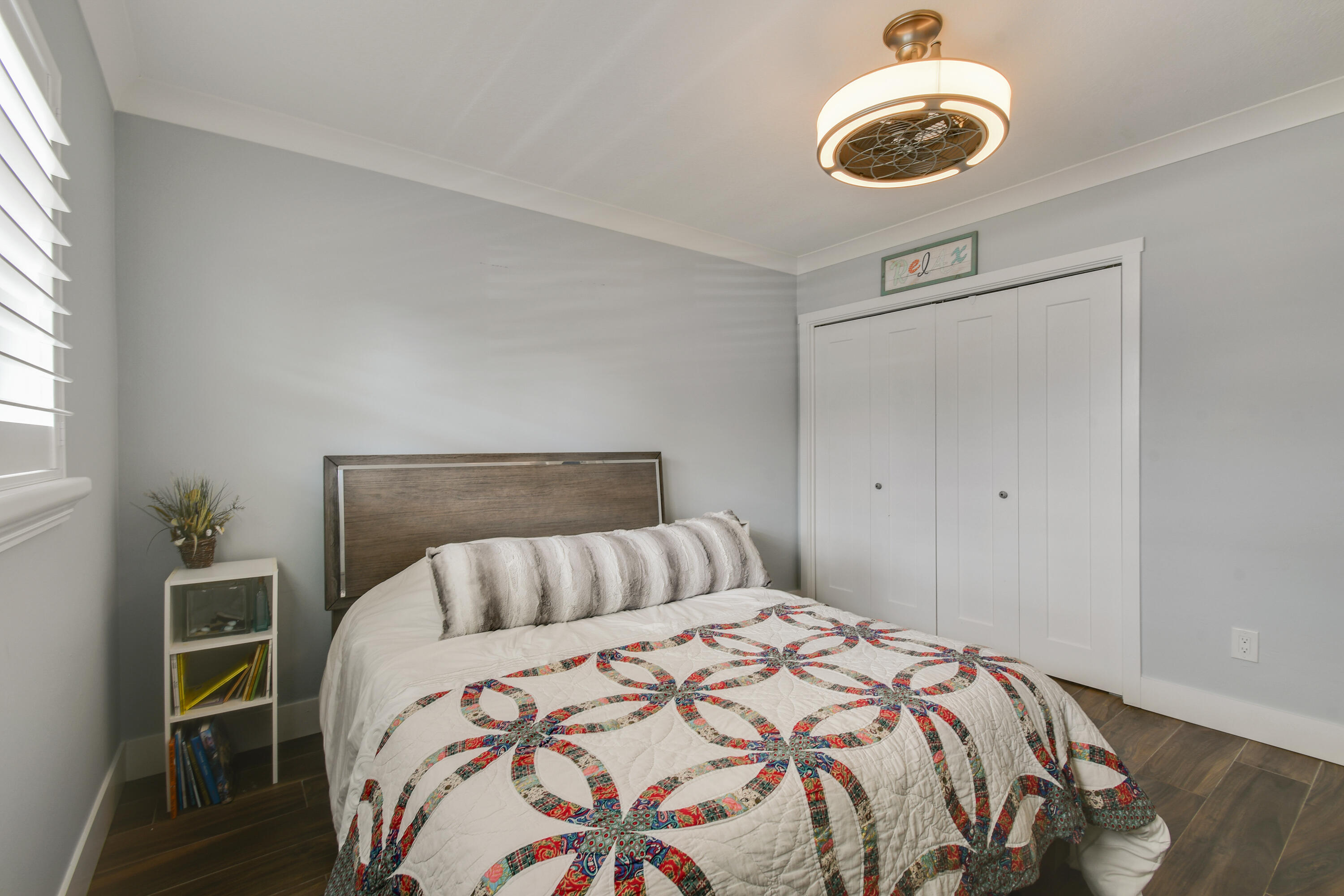 80 Celestial Way, Unit 211 Juno Beach, FL 33408 - Photo 32 of 45 a bedroom with a bed and a chandelier