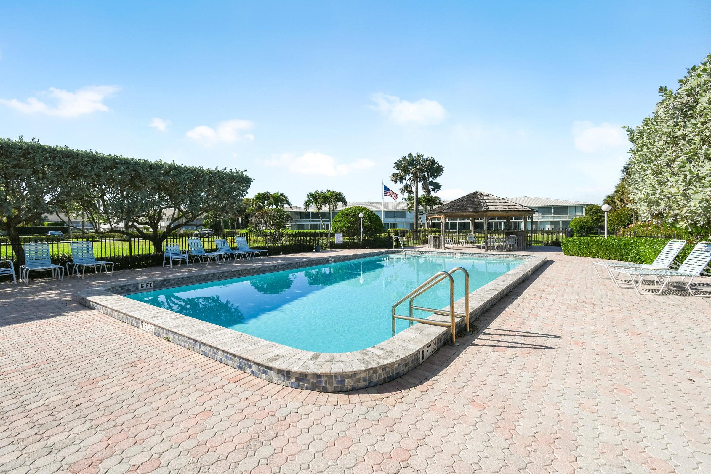 80 Celestial Way, Unit 211 Juno Beach, FL 33408 - Photo 35 of 45 a view of swimming pool with a yard and seating area
