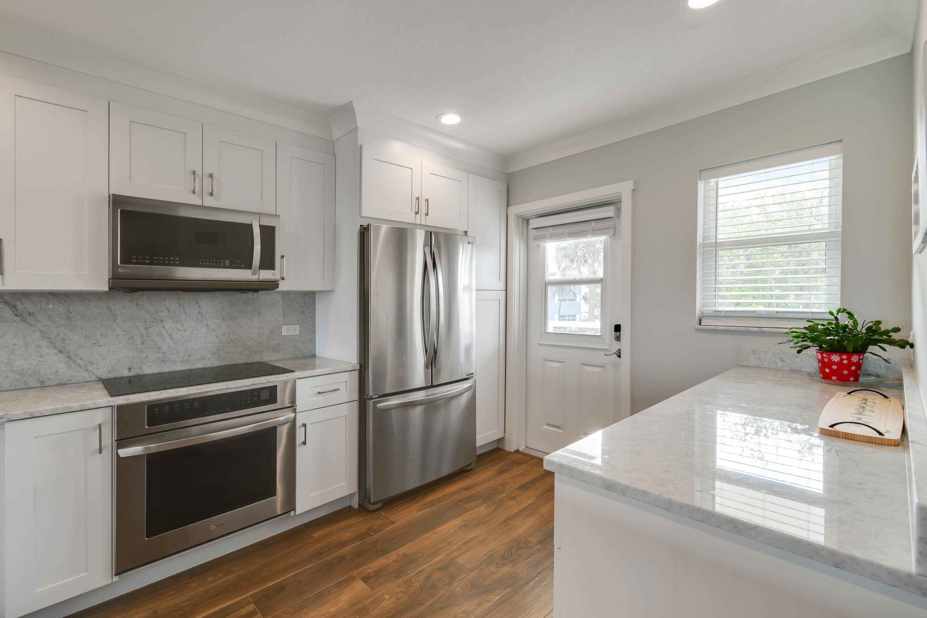80 Celestial Way, Unit 211 Juno Beach, FL 33408 - Photo 4 of 45 a kitchen with granite countertop a refrigerator stove and microwave