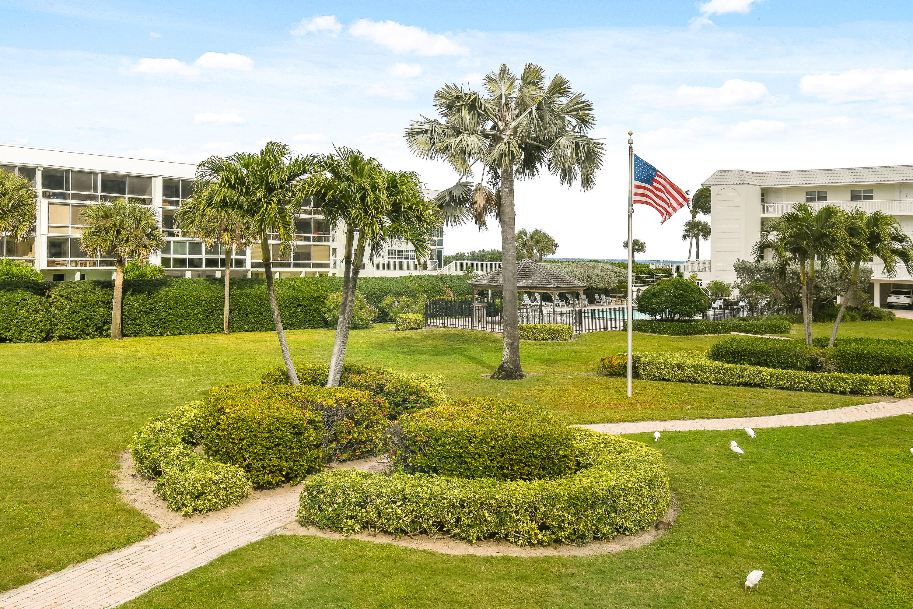 80 Celestial Way, Unit 211 Juno Beach, FL 33408 - Photo 42 of 45 a view of a swimming pool with a yard