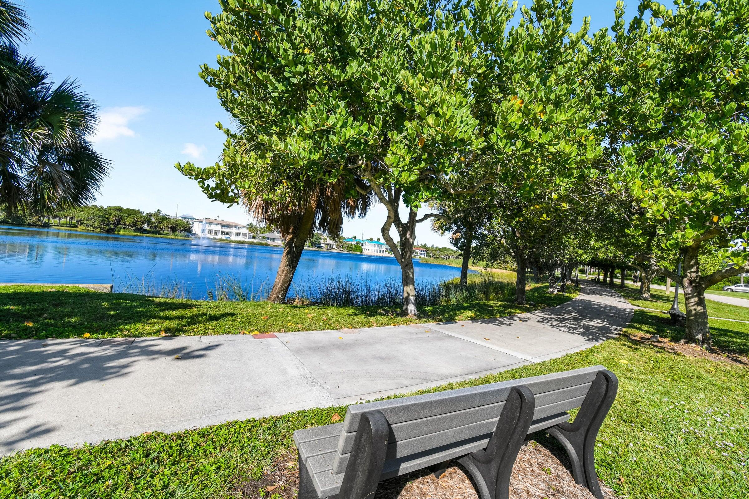 80 Celestial Way, Unit 211 Juno Beach, FL 33408 - Photo 44 of 45 a backyard of a house with trees and wooden fence