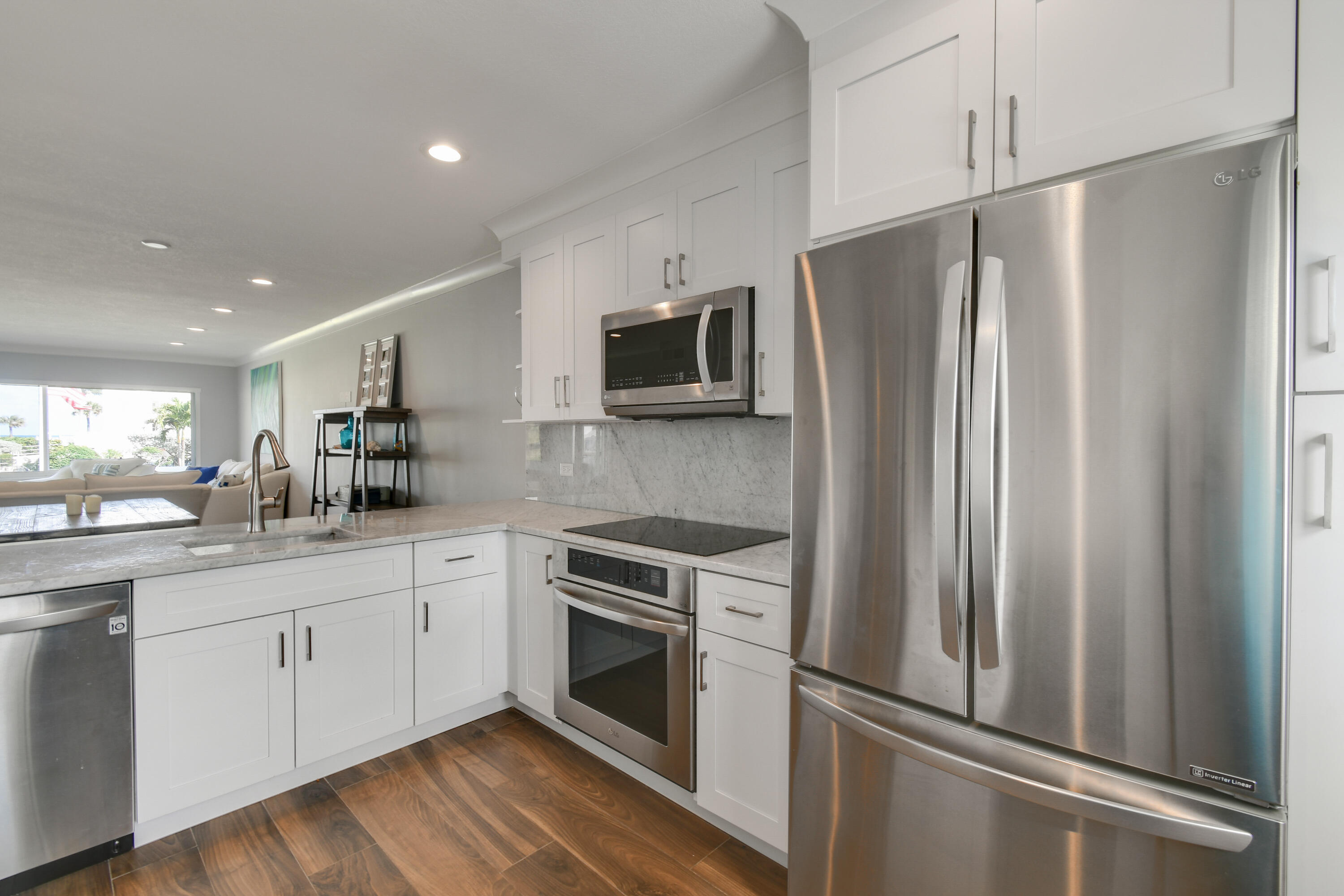 80 Celestial Way, Unit 211 Juno Beach, FL 33408 - Photo 6 of 45 a kitchen with a refrigerator sink and microwave