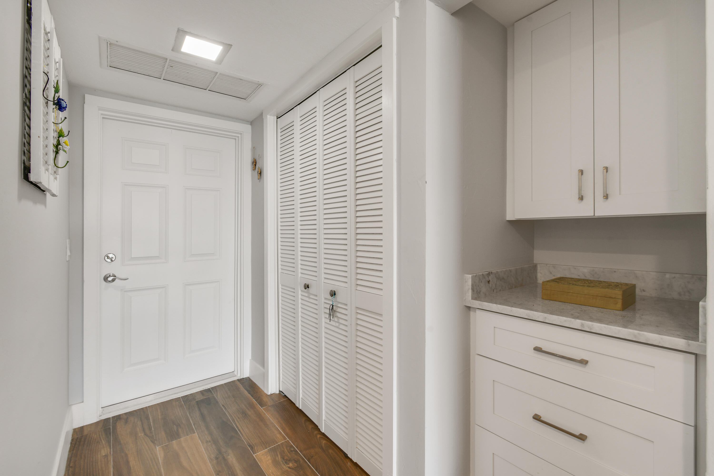 80 Celestial Way, Unit 211 Juno Beach, FL 33408 - Photo 9 of 45 a view of cabinets and wooden floor