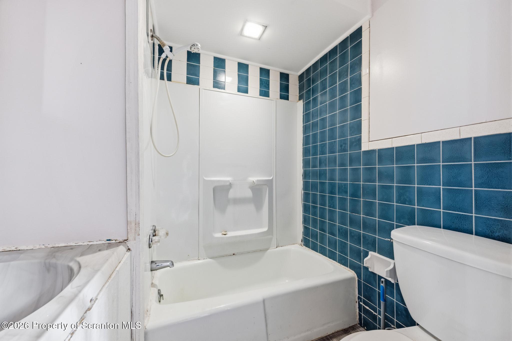 1413 Bulwer Street Scranton, PA 18504 - Photo 11 of 45 a bathroom with a sink and bathtub with toilet