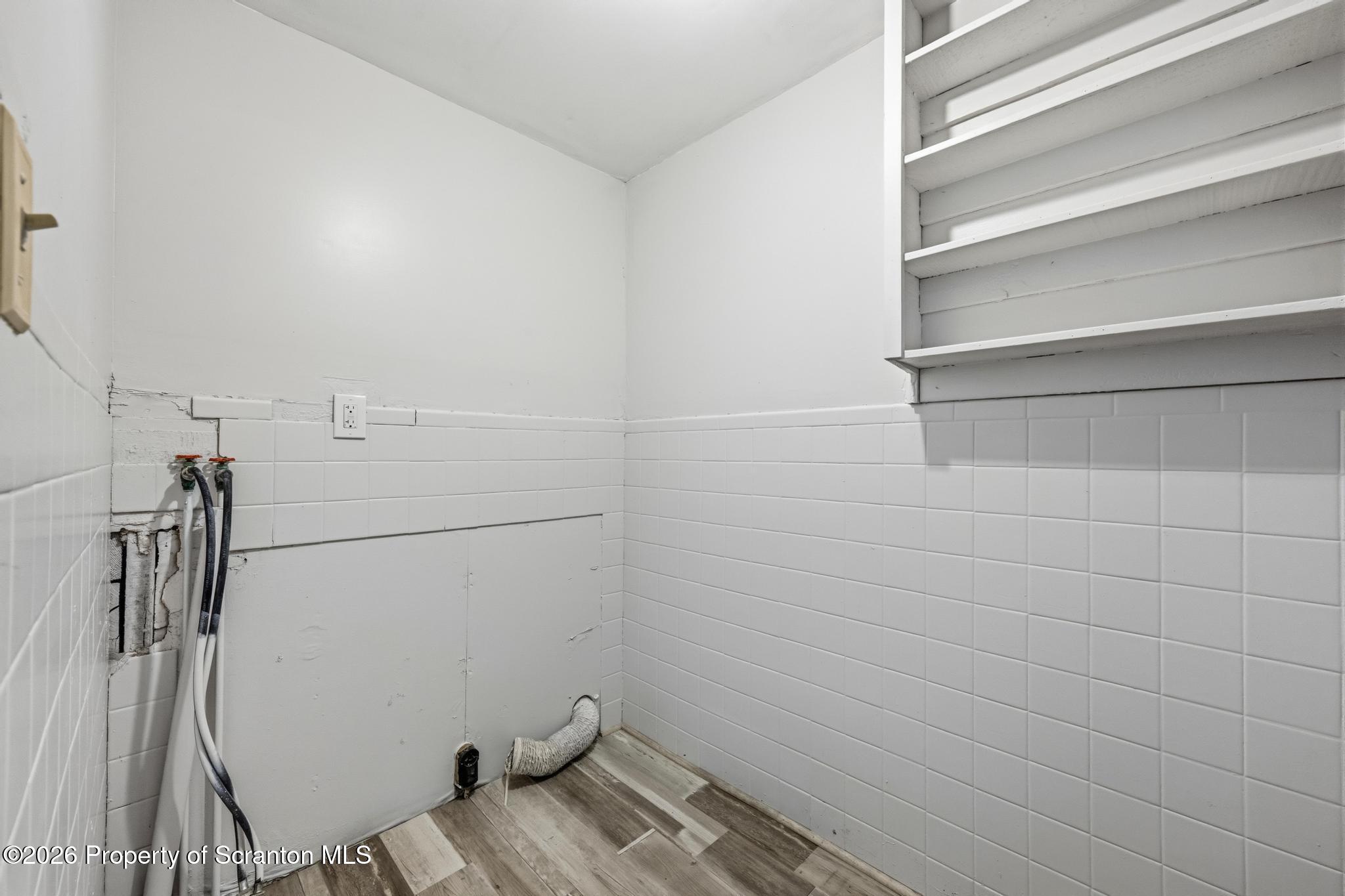 1413 Bulwer Street Scranton, PA 18504 - Photo 13 of 45 a view of storage and utility room with racks on the wall