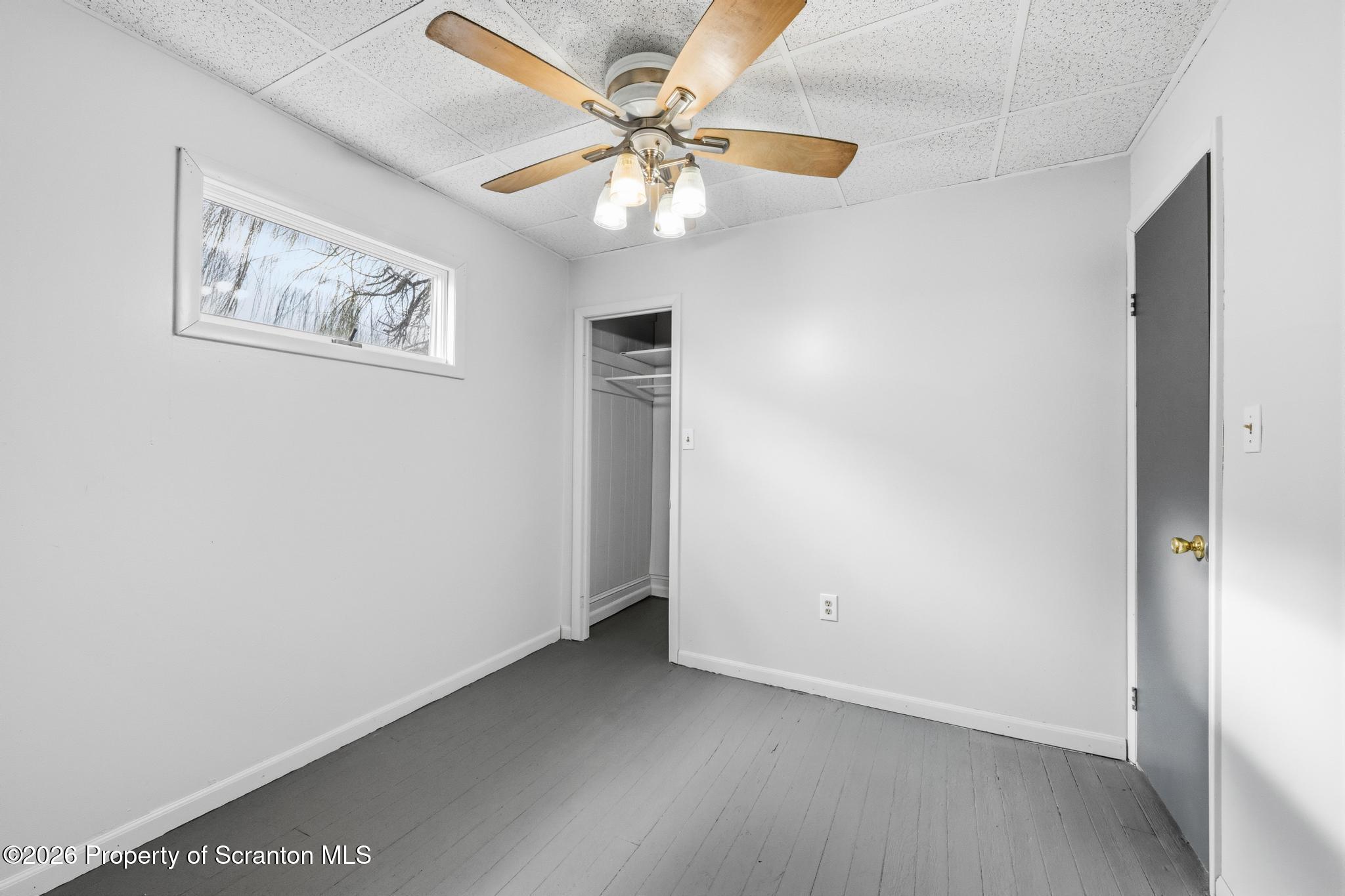 1413 Bulwer Street Scranton, PA 18504 - Photo 16 of 45 an empty room with windows and fan