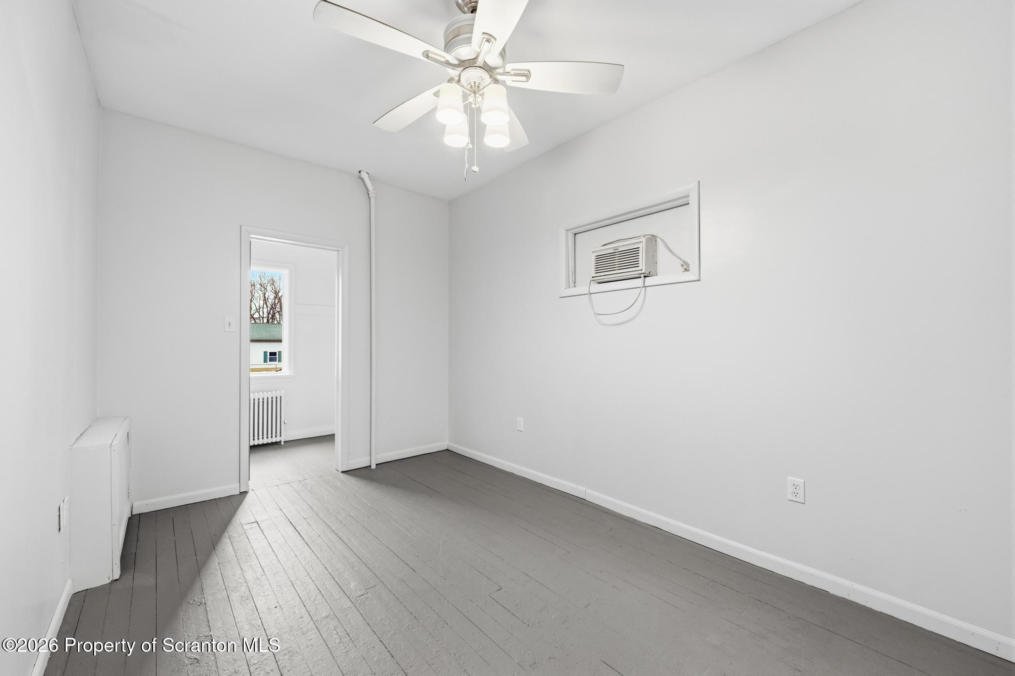1413 Bulwer Street Scranton, PA 18504 - Photo 19 of 45 wooden floor in an empty room with a window