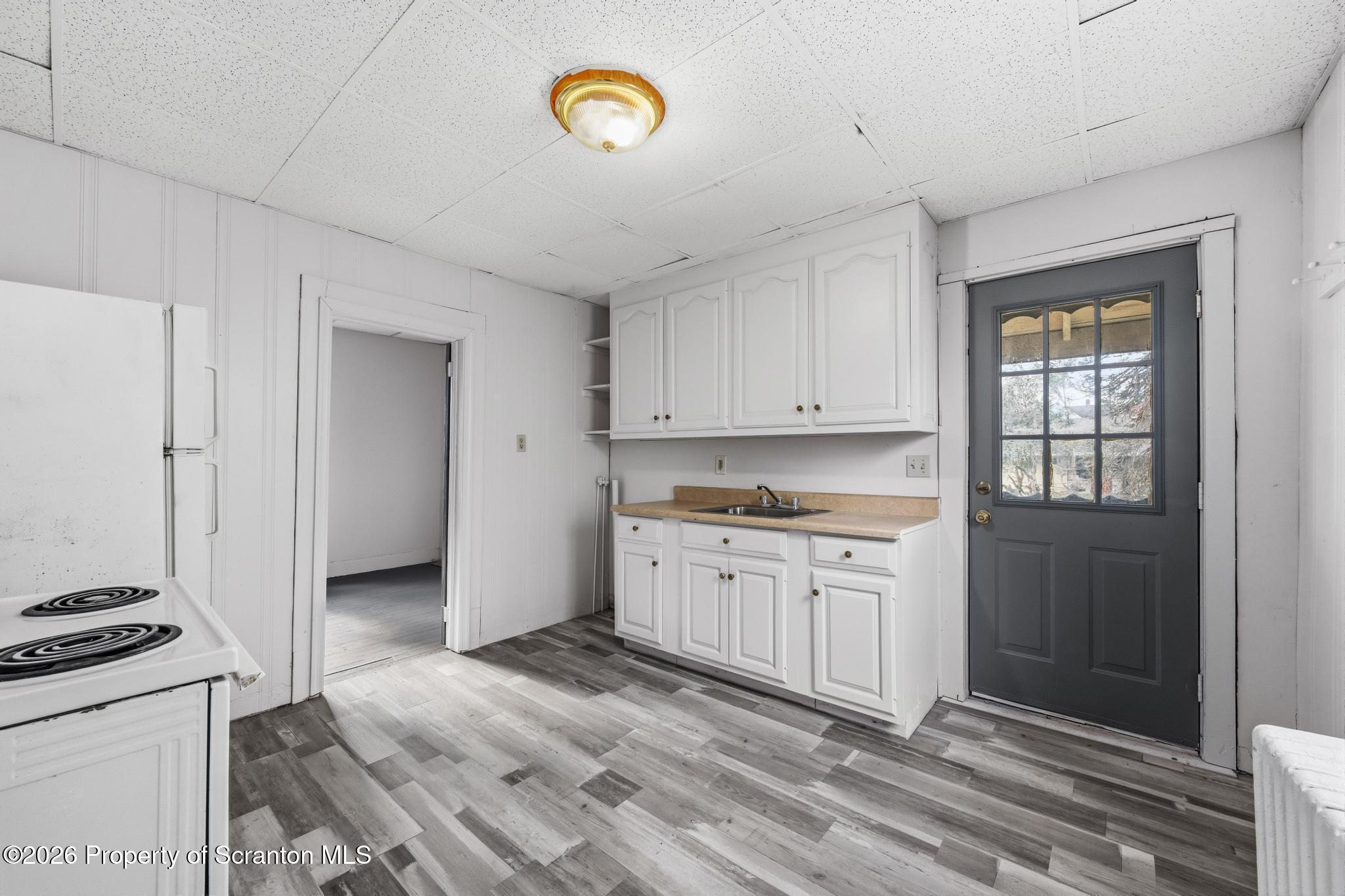 1413 Bulwer Street Scranton, PA 18504 - Photo 22 of 45 a kitchen with granite countertop a stove a sink and a refrigerator