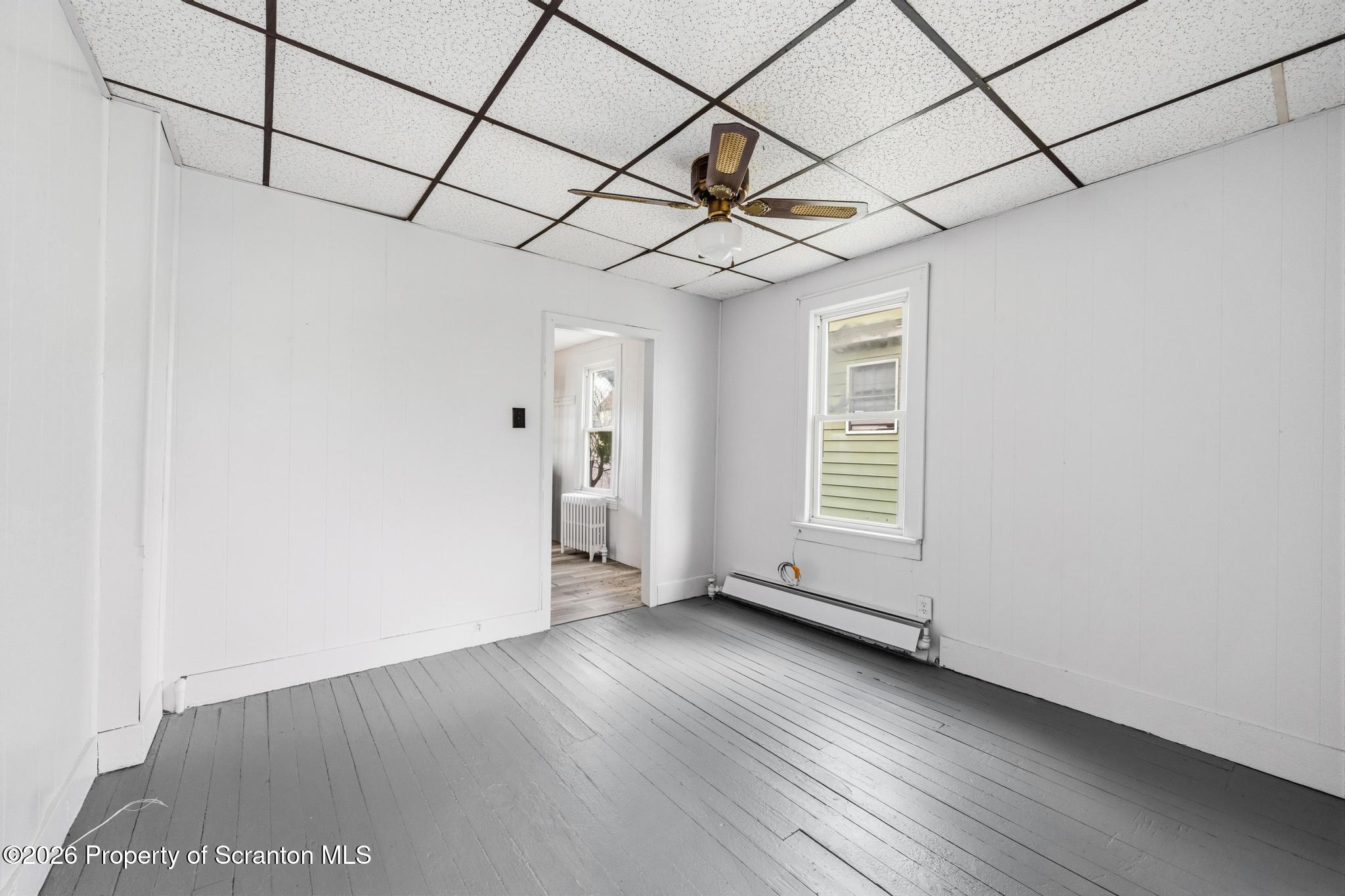 1413 Bulwer Street Scranton, PA 18504 - Photo 27 of 45 a view of a livingroom with wooden floor and a ceiling fan