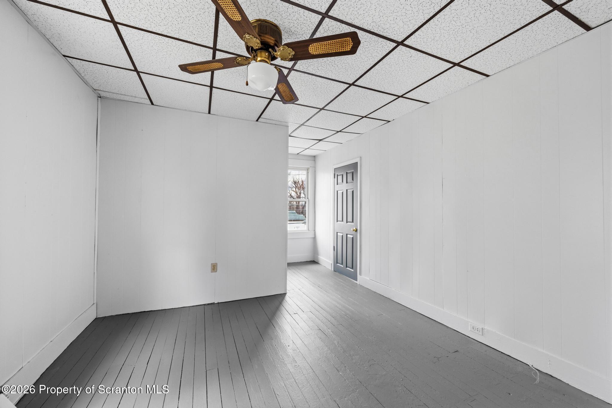 1413 Bulwer Street Scranton, PA 18504 - Photo 30 of 45 a view of a room with wooden floor and white walls