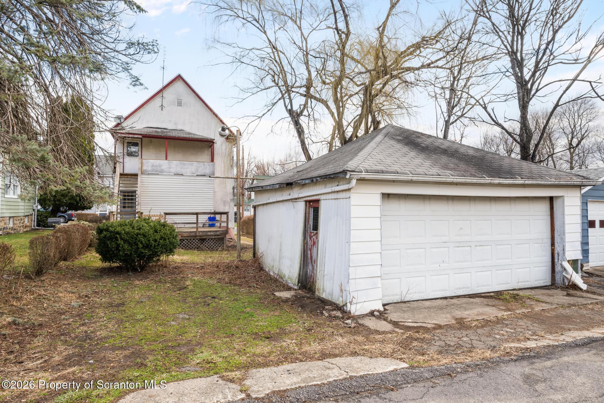 1413 Bulwer Street Scranton, PA 18504 - Photo 35 of 45 a front view of a house with a yard and garage