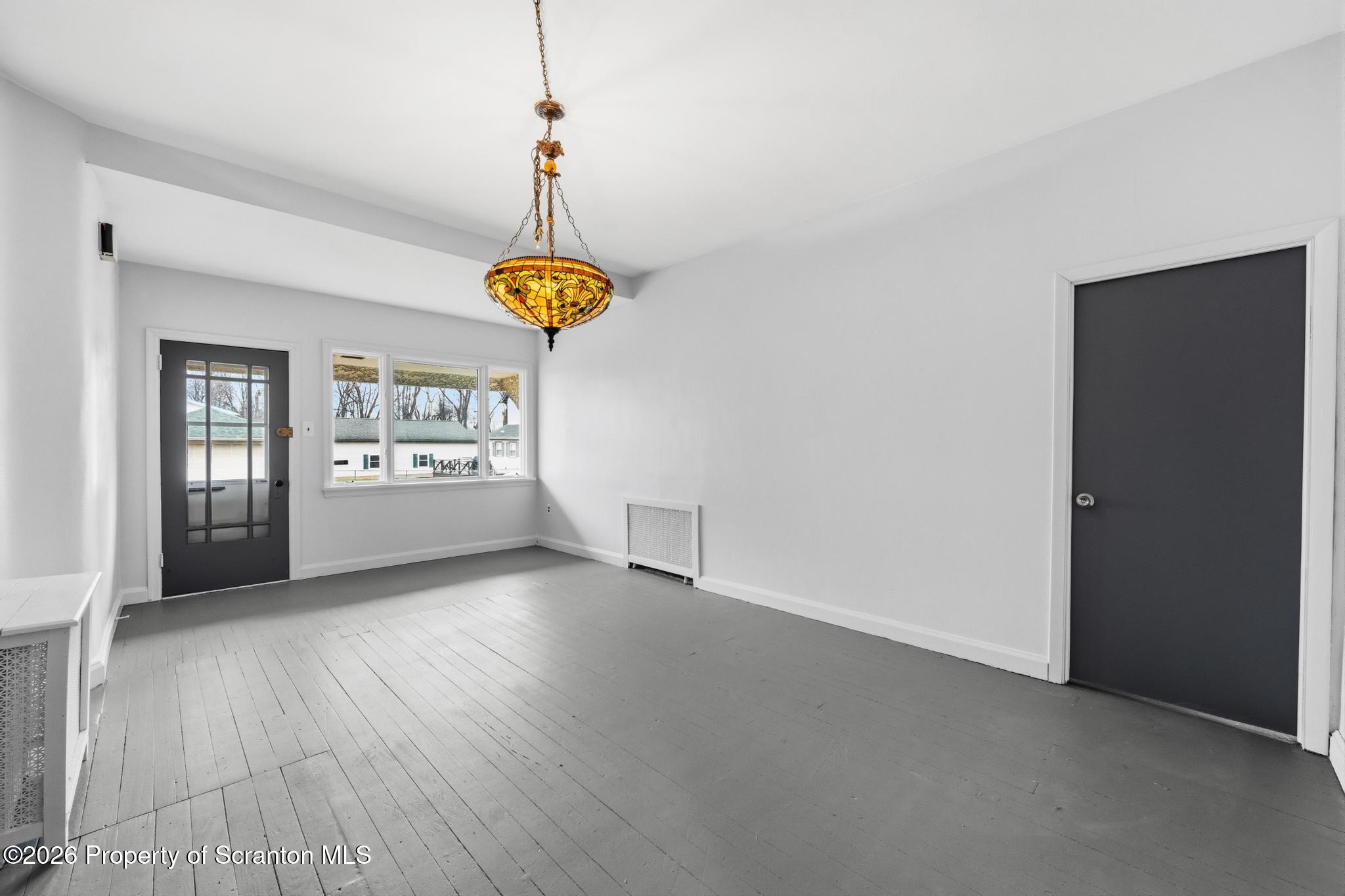 1413 Bulwer Street Scranton, PA 18504 - Photo 9 of 45 a view of an empty room with window and wooden floor
