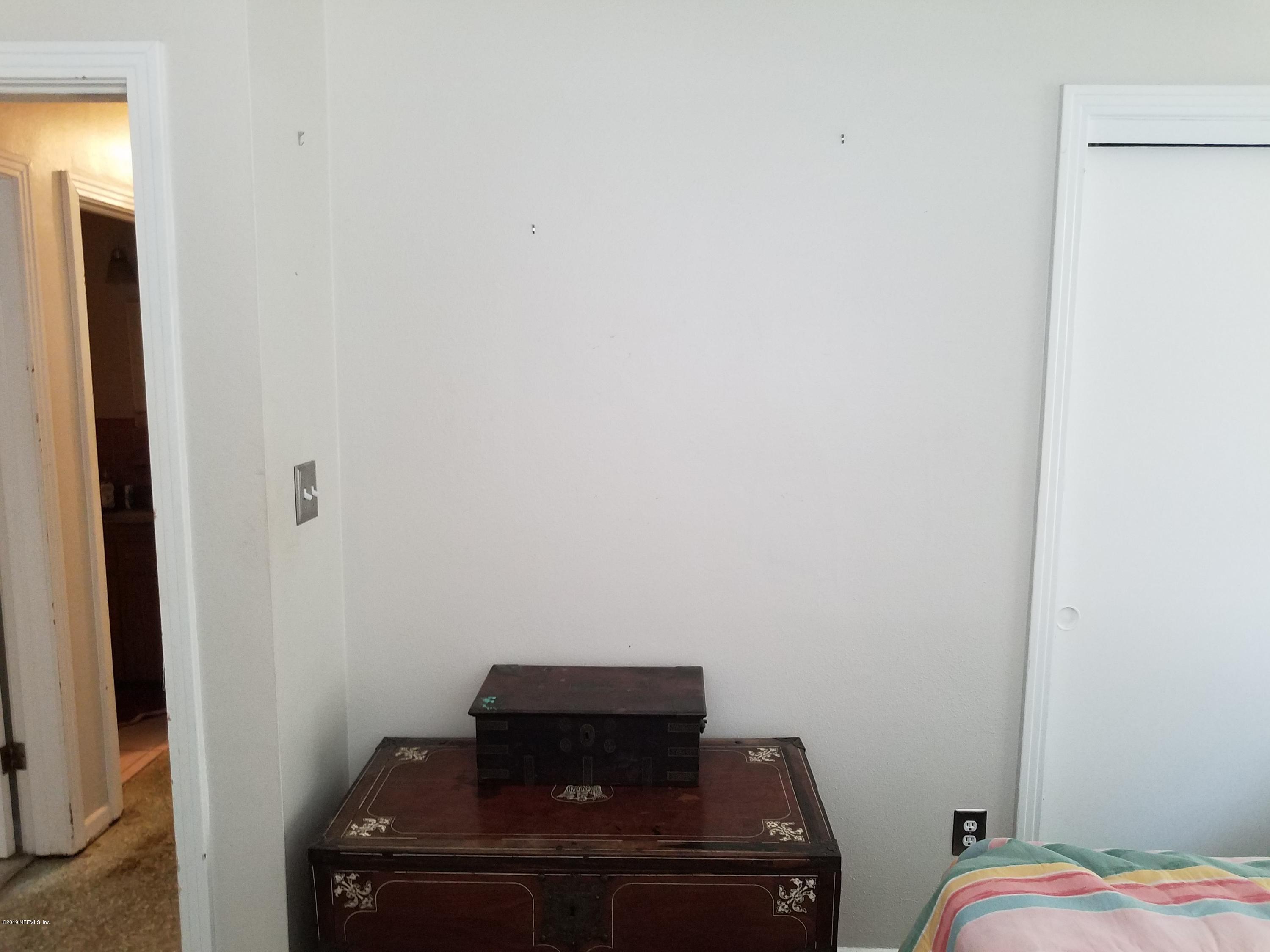 214 Southwest 40th Street Gainesville, FL 32607 - Photo 15 of 68 a room with a bed and wooden floor