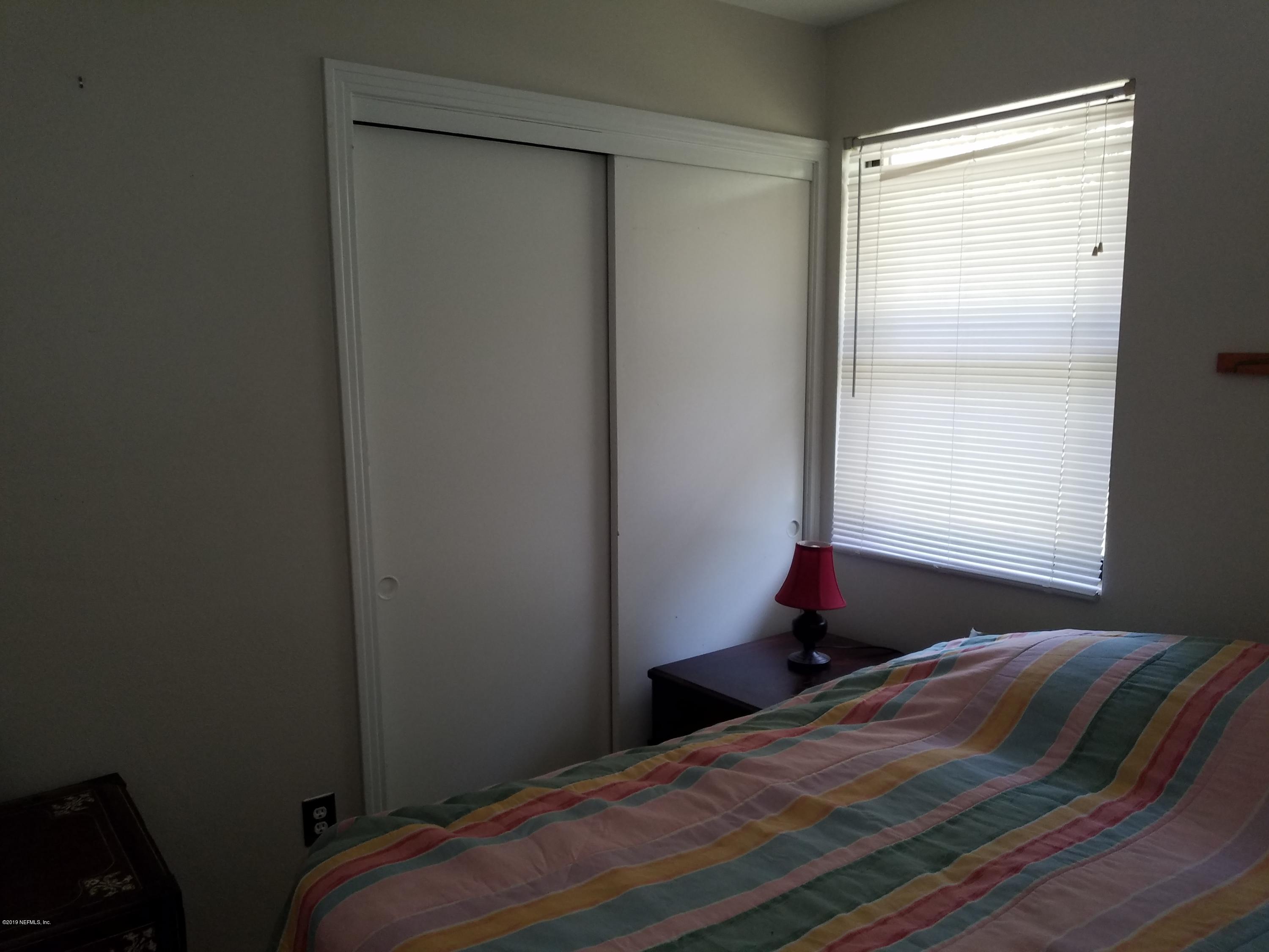 214 Southwest 40th Street Gainesville, FL 32607 - Photo 16 of 68 a bedroom with a bed and a window