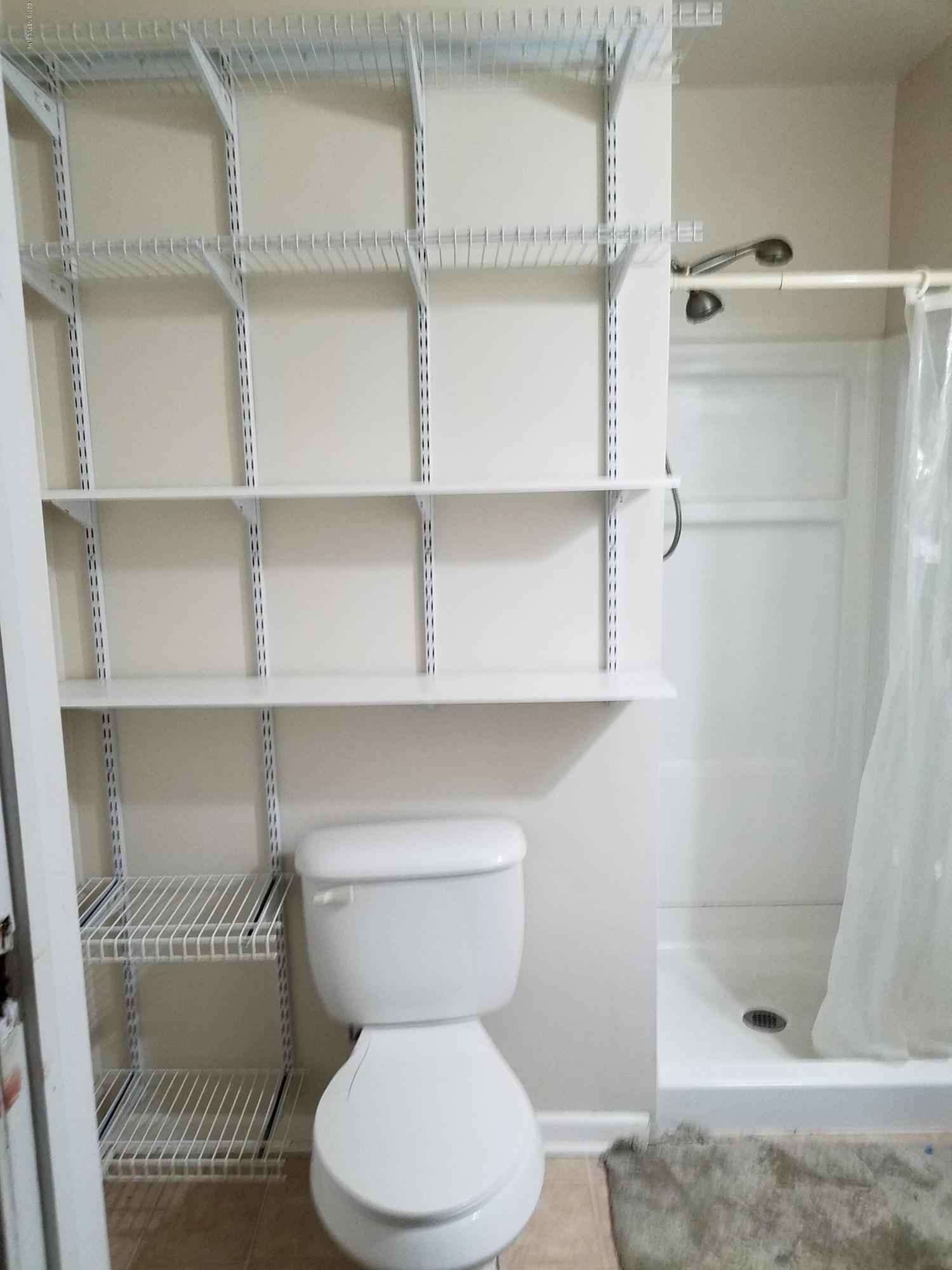 214 Southwest 40th Street Gainesville, FL 32607 - Photo 18 of 68 a bathroom with a toilet and a shower