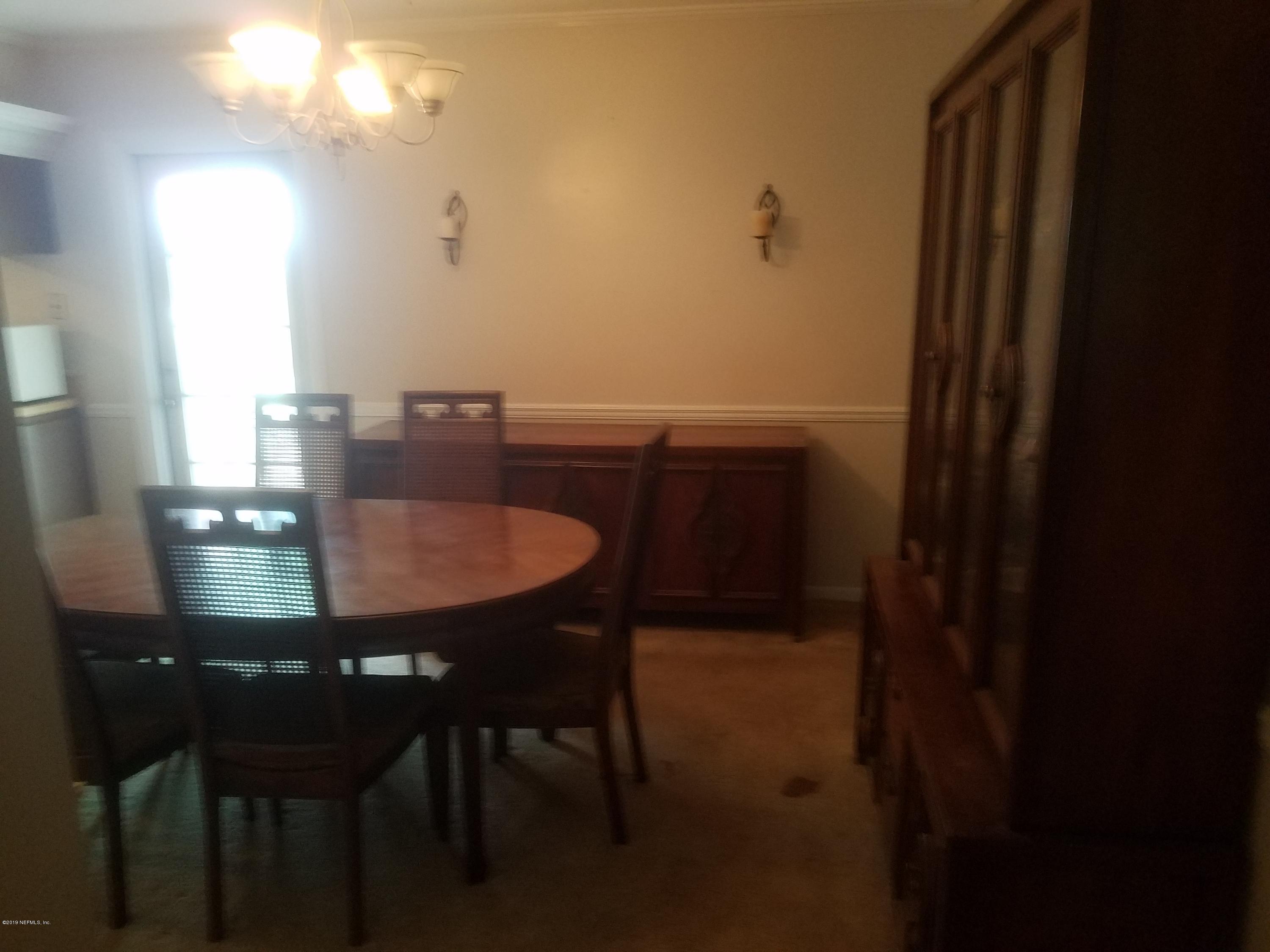 214 Southwest 40th Street Gainesville, FL 32607 - Photo 47 of 68 a dining room with furniture and wooden floor