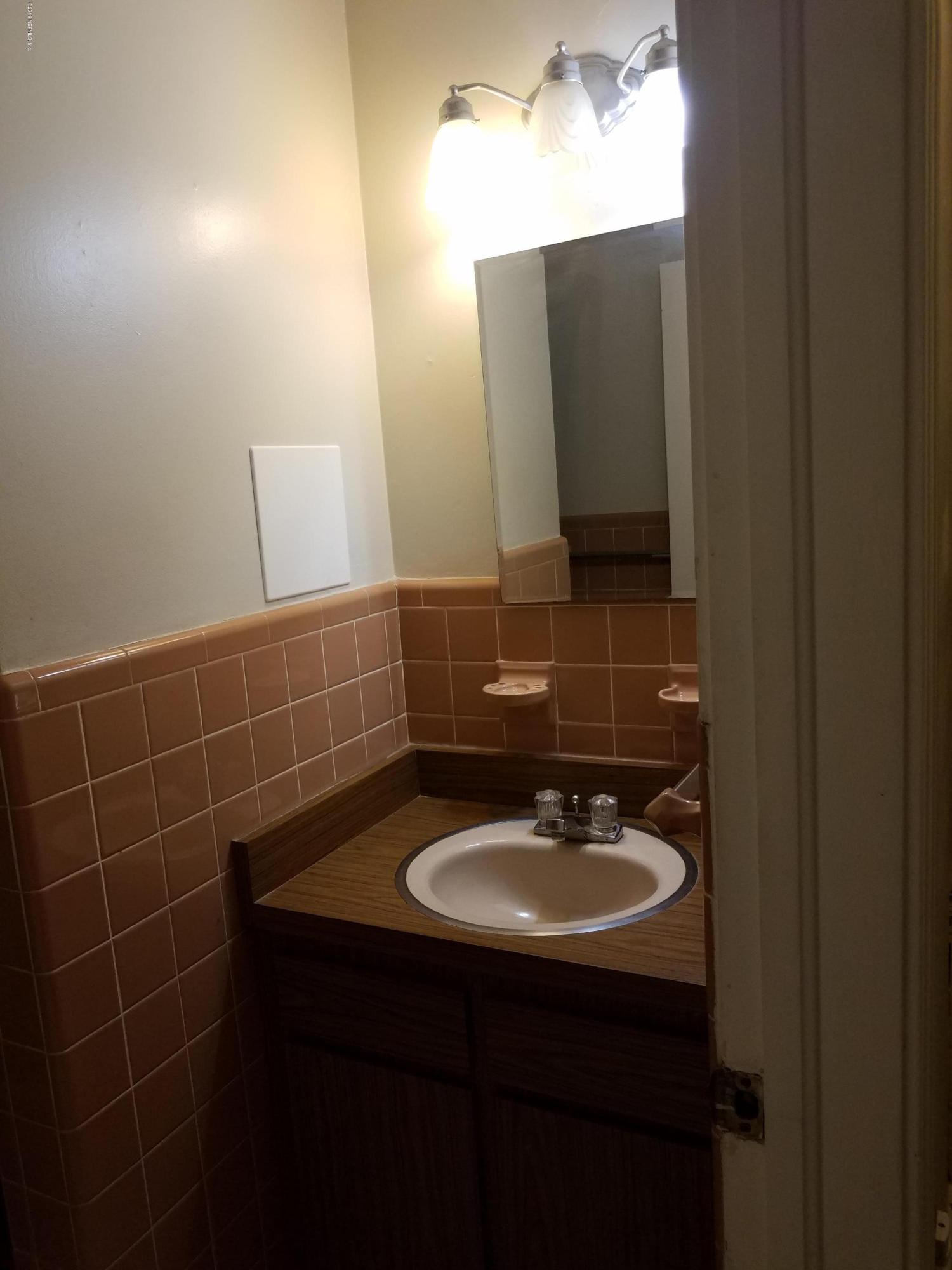 214 Southwest 40th Street Gainesville, FL 32607 - Photo 5 of 68 a bathroom with a sink and a mirror