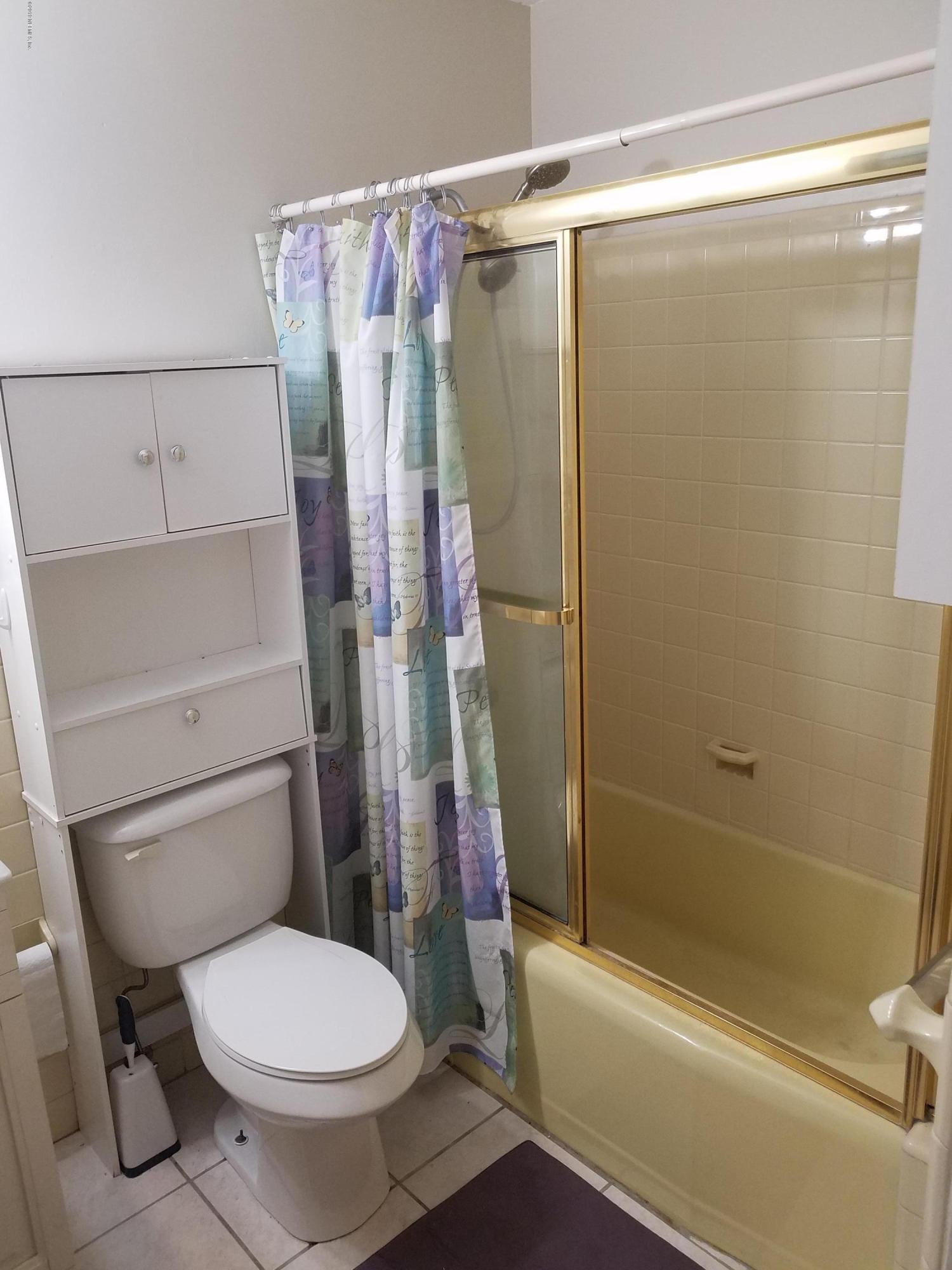 214 Southwest 40th Street Gainesville, FL 32607 - Photo 55 of 68 a white toilet sitting next to a bath tub and a shower