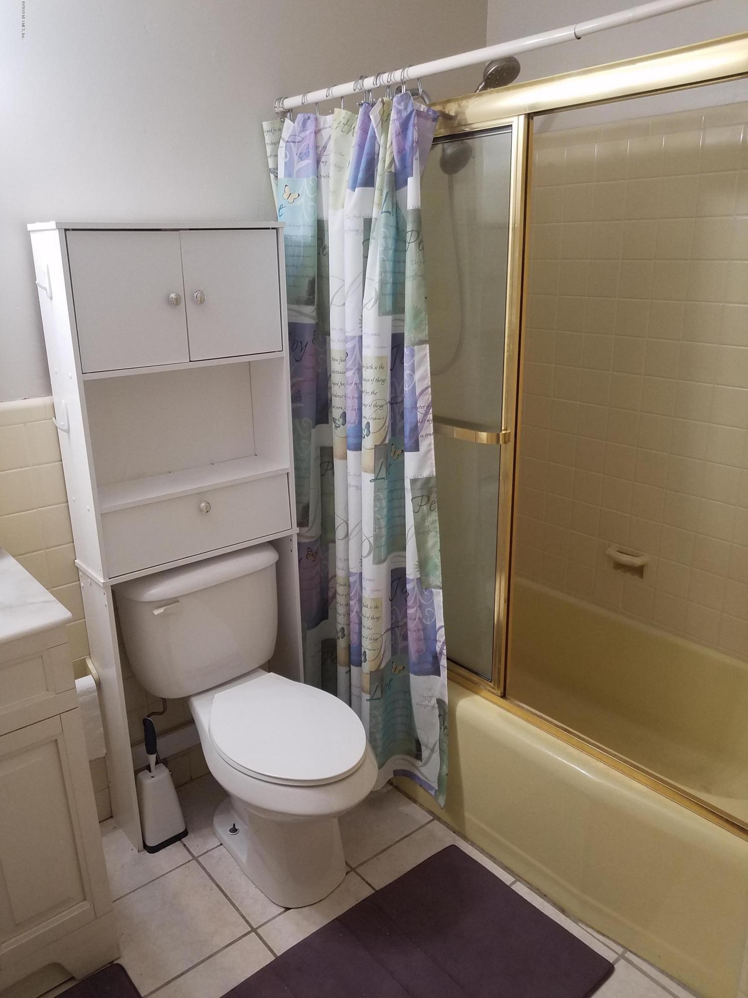 214 Southwest 40th Street Gainesville, FL 32607 - Photo 56 of 68 a white toilet sitting next to a bath tub