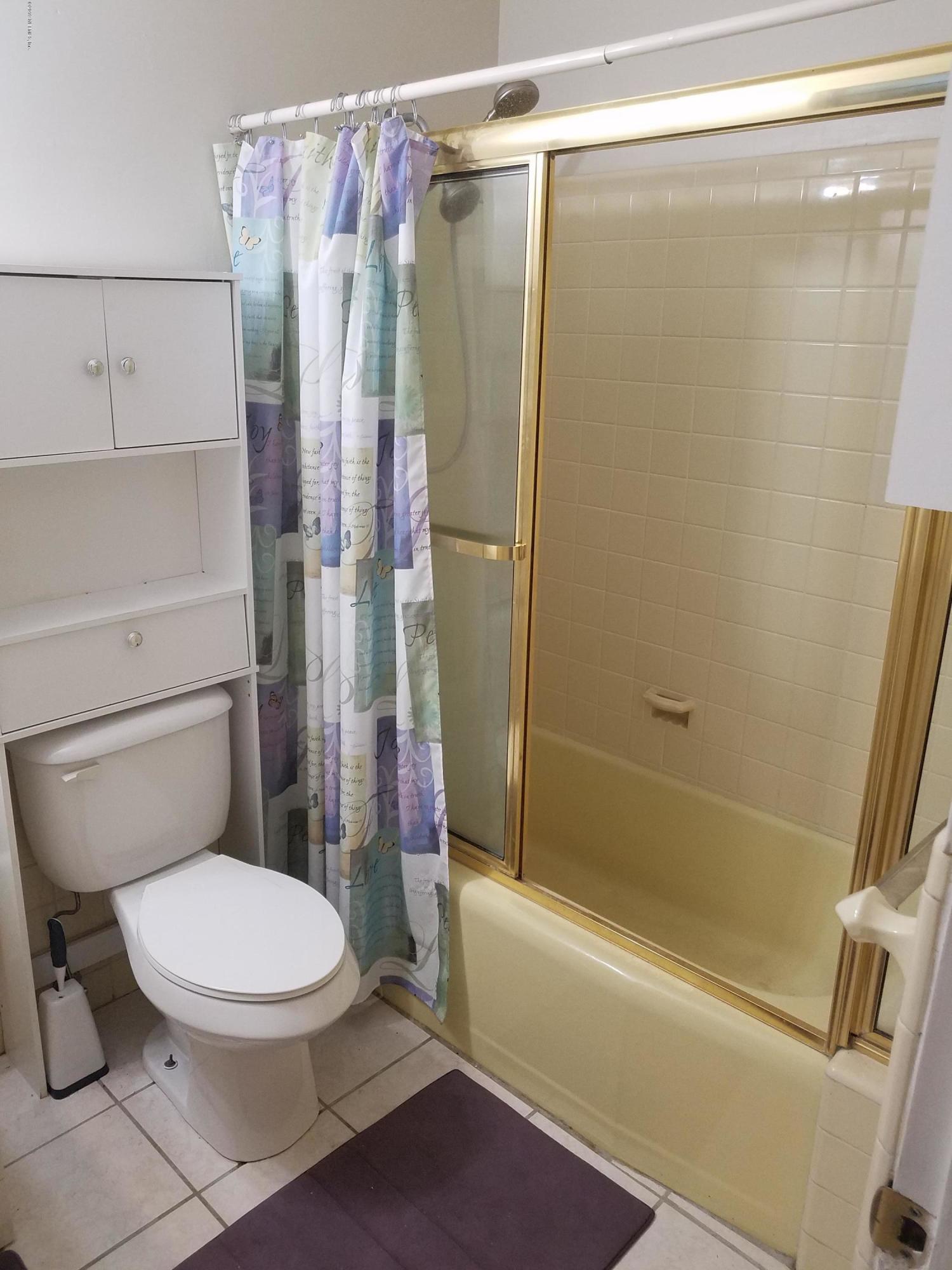 214 Southwest 40th Street Gainesville, FL 32607 - Photo 57 of 68 a white toilet sitting next to a bath tub