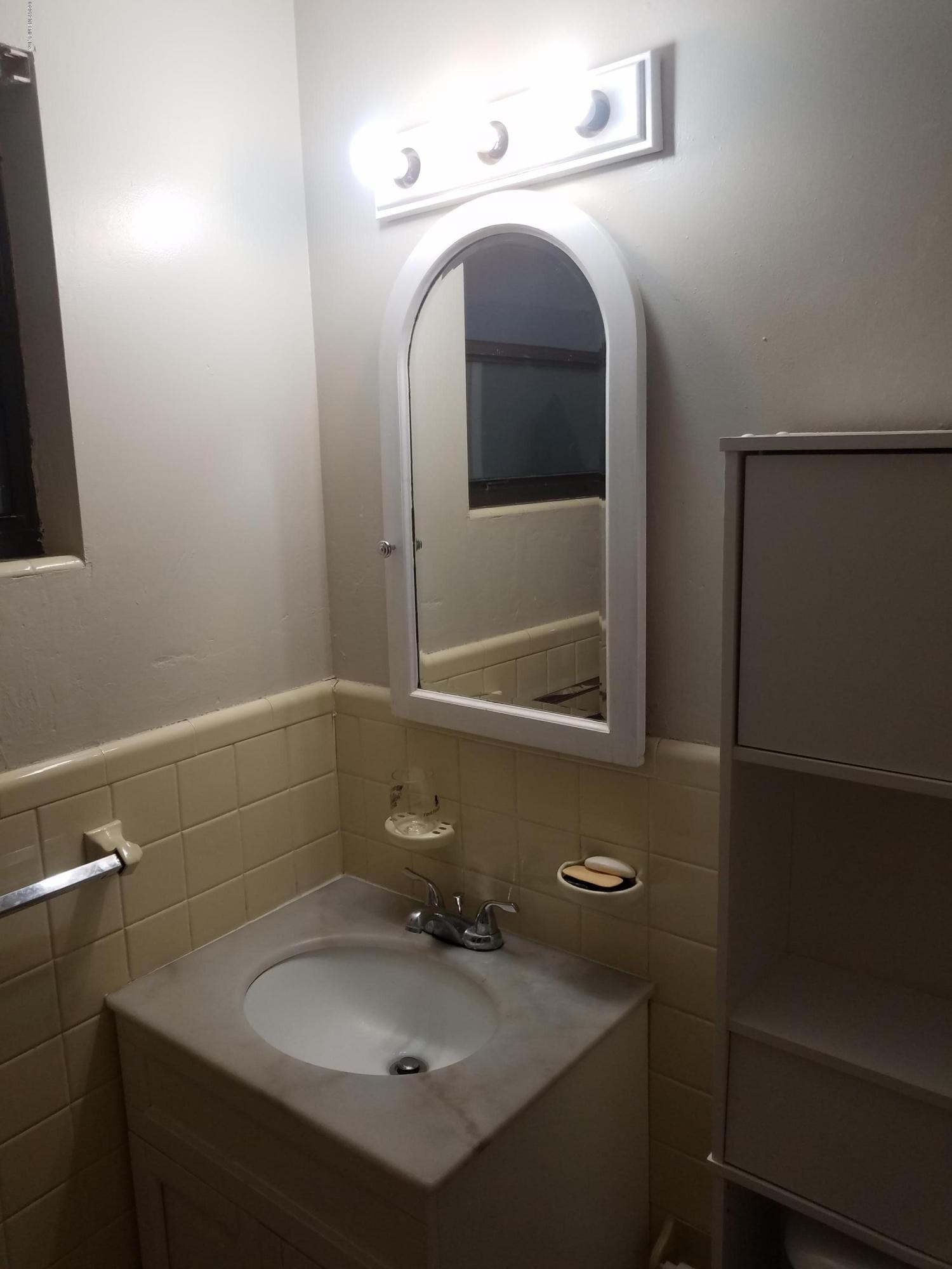 214 Southwest 40th Street Gainesville, FL 32607 - Photo 59 of 68 a bathroom with a sink and mirror