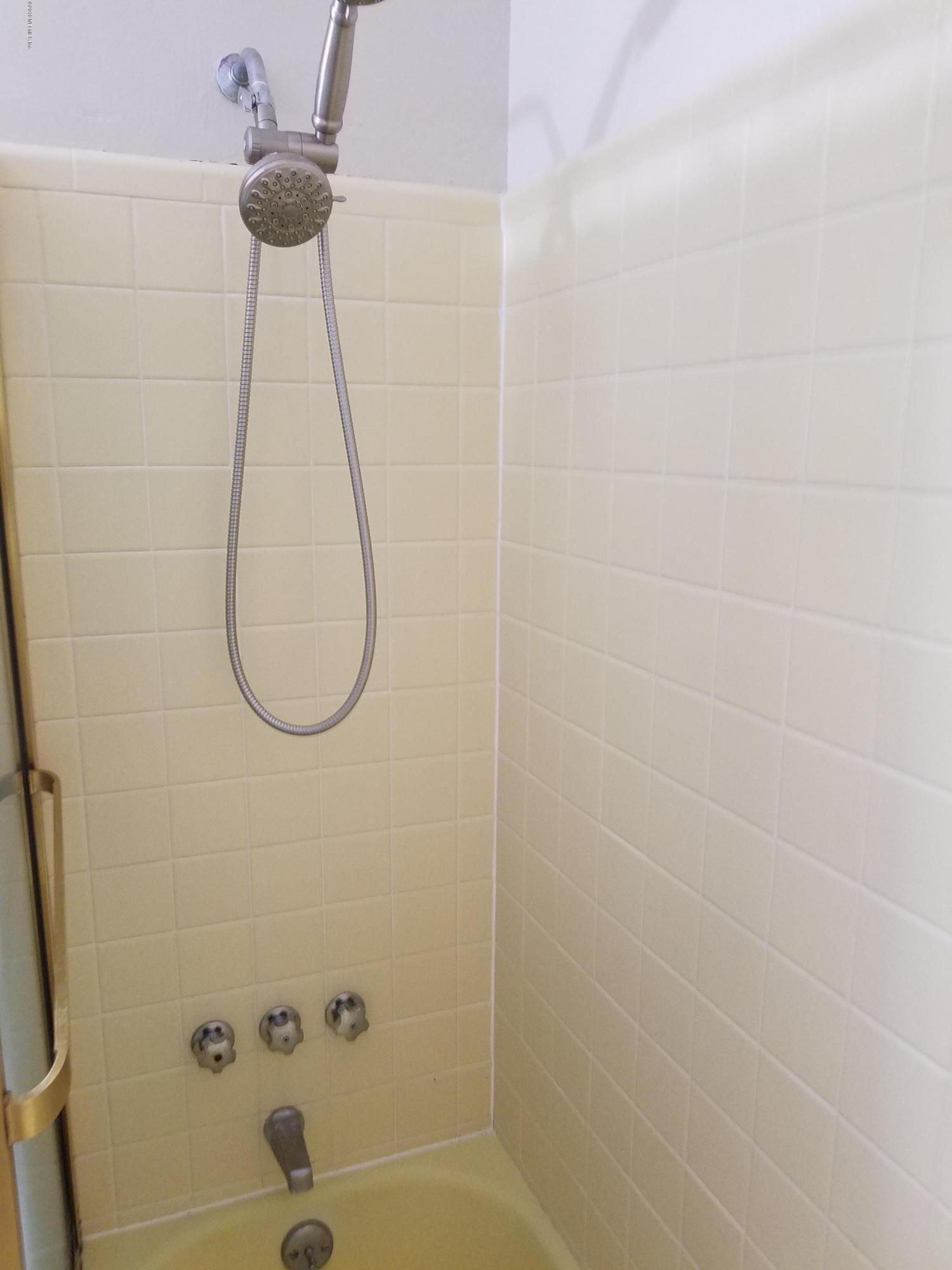 214 Southwest 40th Street Gainesville, FL 32607 - Photo 61 of 68 a bathroom with a shower and a mirror