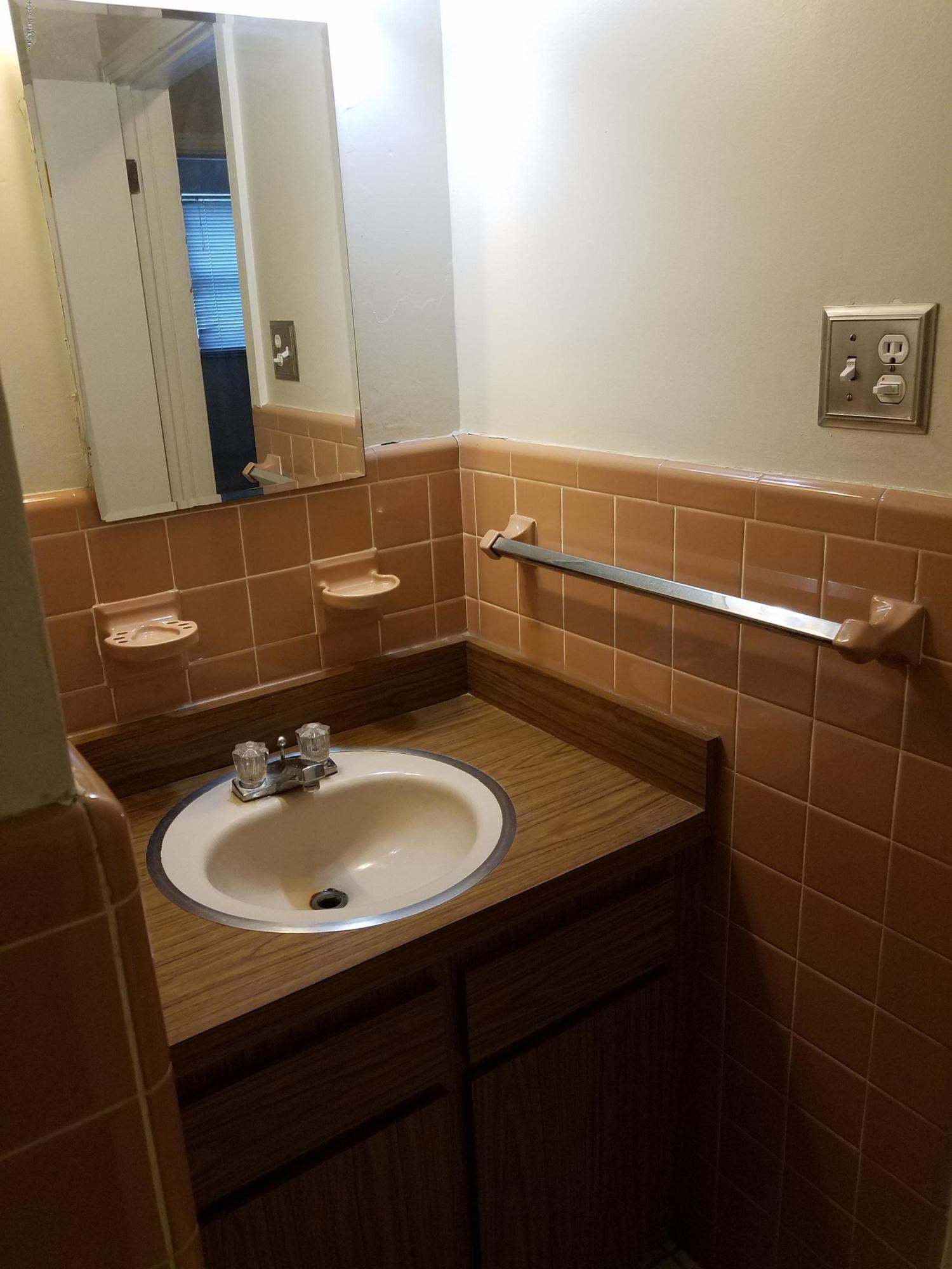 214 Southwest 40th Street Gainesville, FL 32607 - Photo 7 of 68 a bathroom with a sink and a mirror
