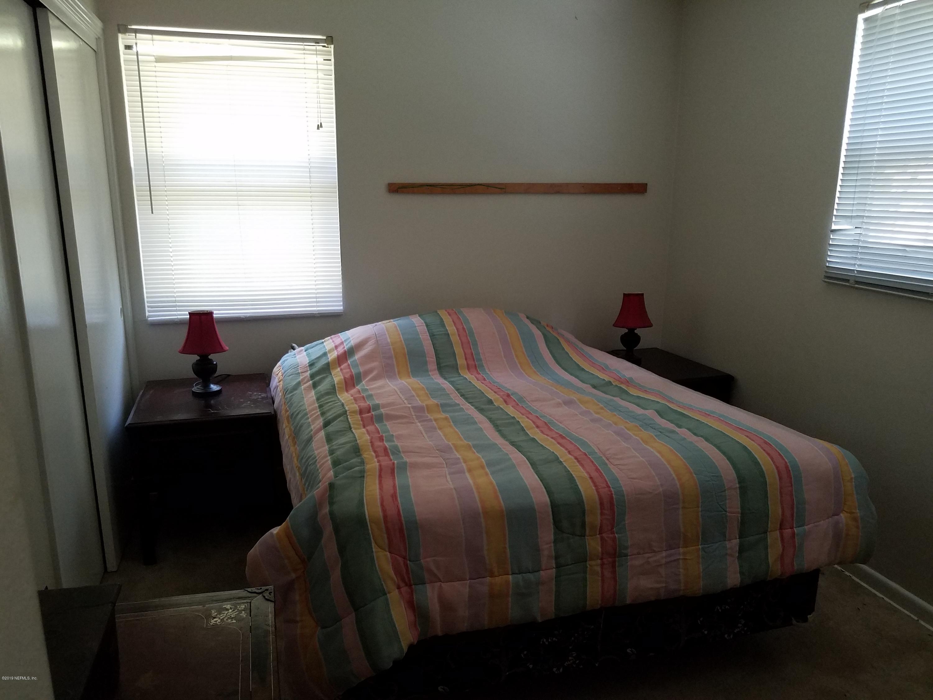 214 Southwest 40th Street Gainesville, FL 32607 - Photo 9 of 68 a bed sitting in a bedroom next to a window