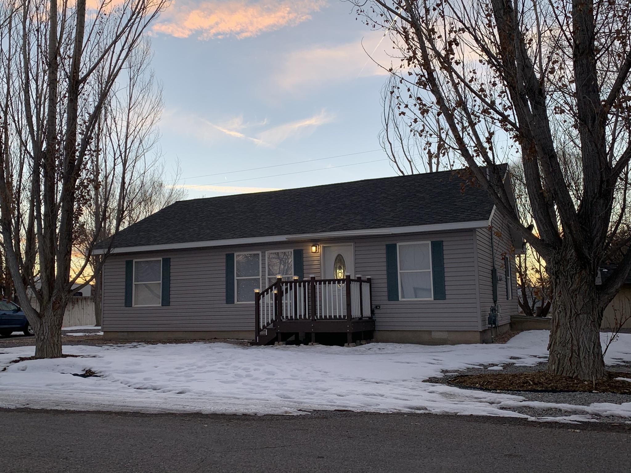 837 Alpine Road Montrose, CO 81403 - Photo 2 of 16 a house that has a tree in front of it